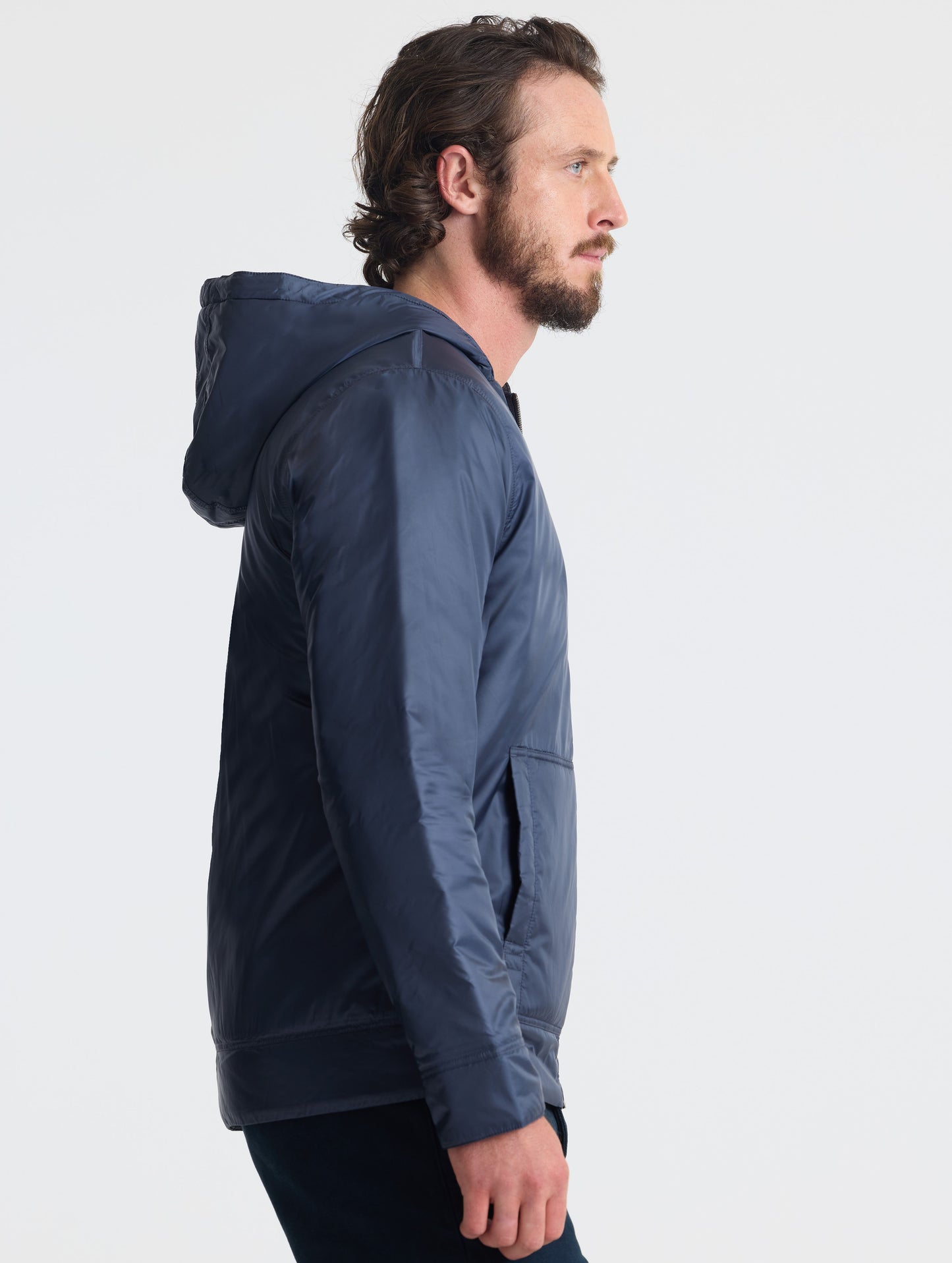 Right profile view of man wearing Eco Space Hoodie in Total Eclipse dark blue from AETHER Apparel.