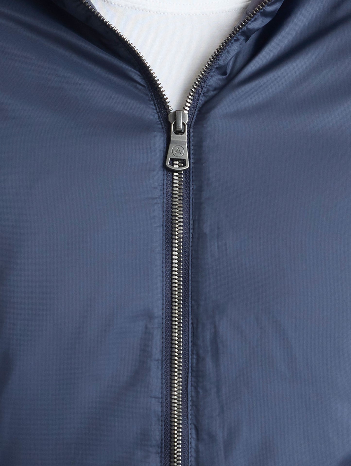 Closeup view of center zipper of Eco Space Hoodie in Total Eclipse dark blue from AETHER Apparel.