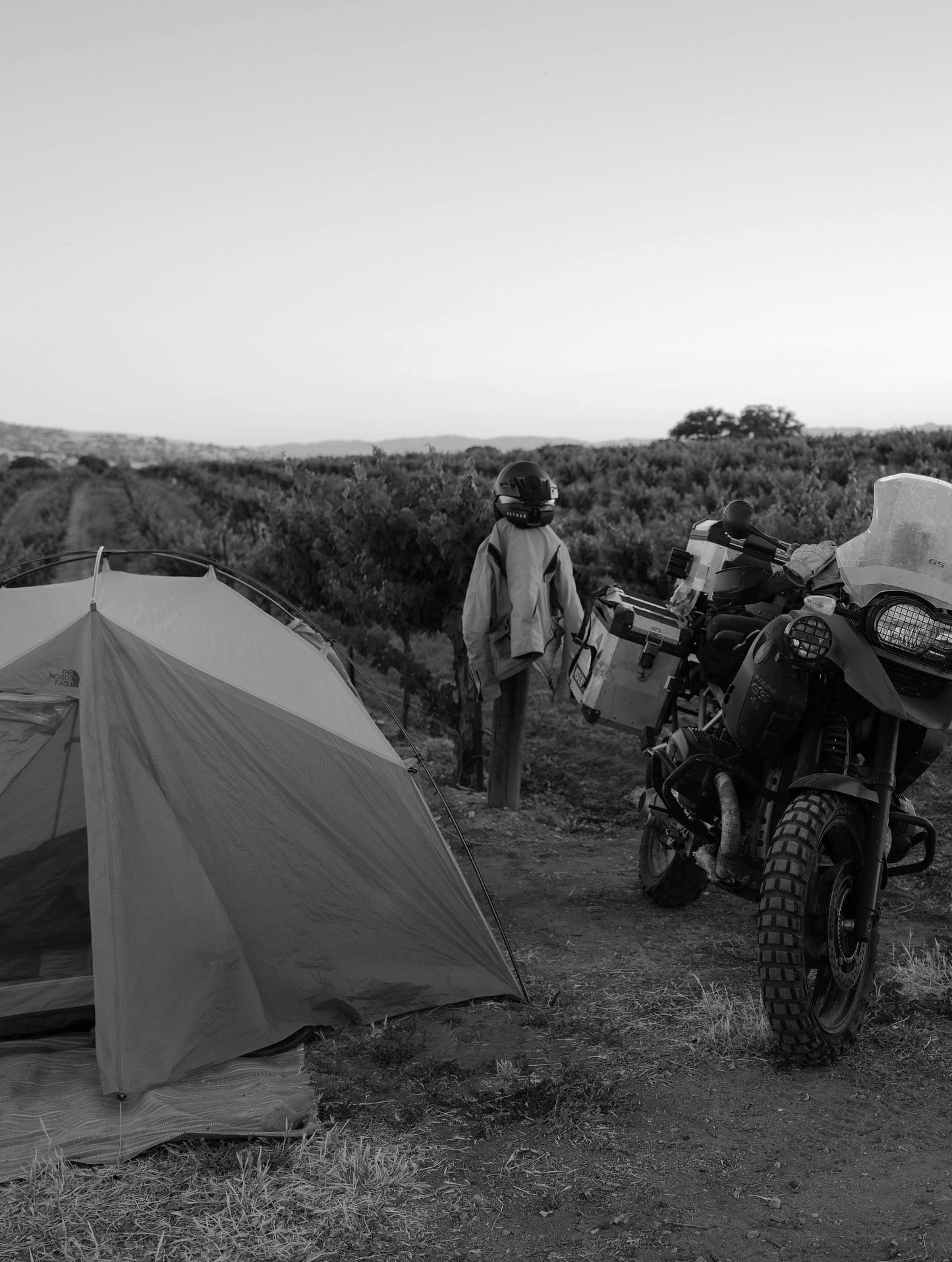 Motorycle, tent, and AETHER products nested amongst nature in Paso Robles, California.