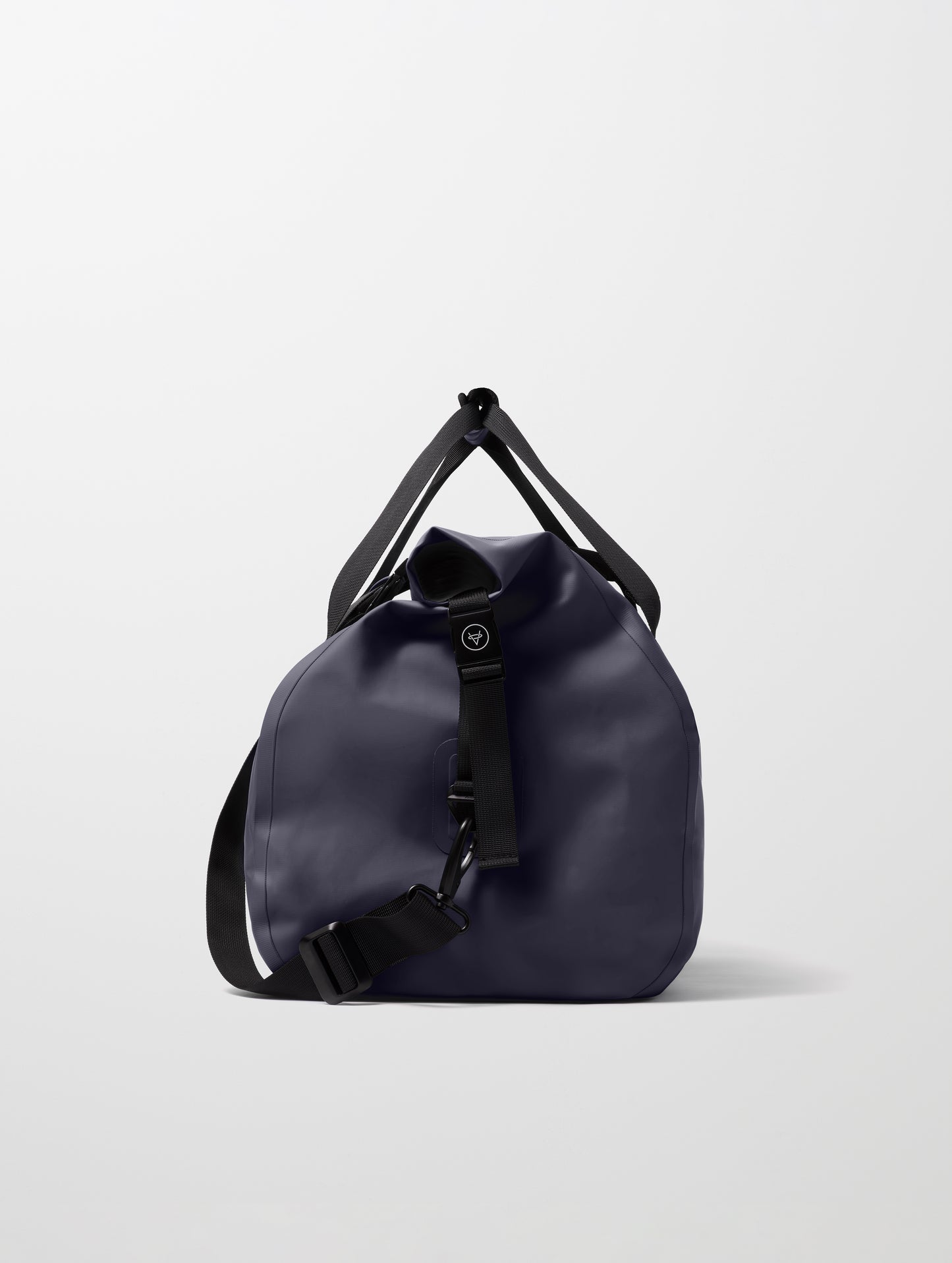 Side profile view of Excursion Duffle Bag 45L in Total Eclipse dark blue from AETHER Apparel.