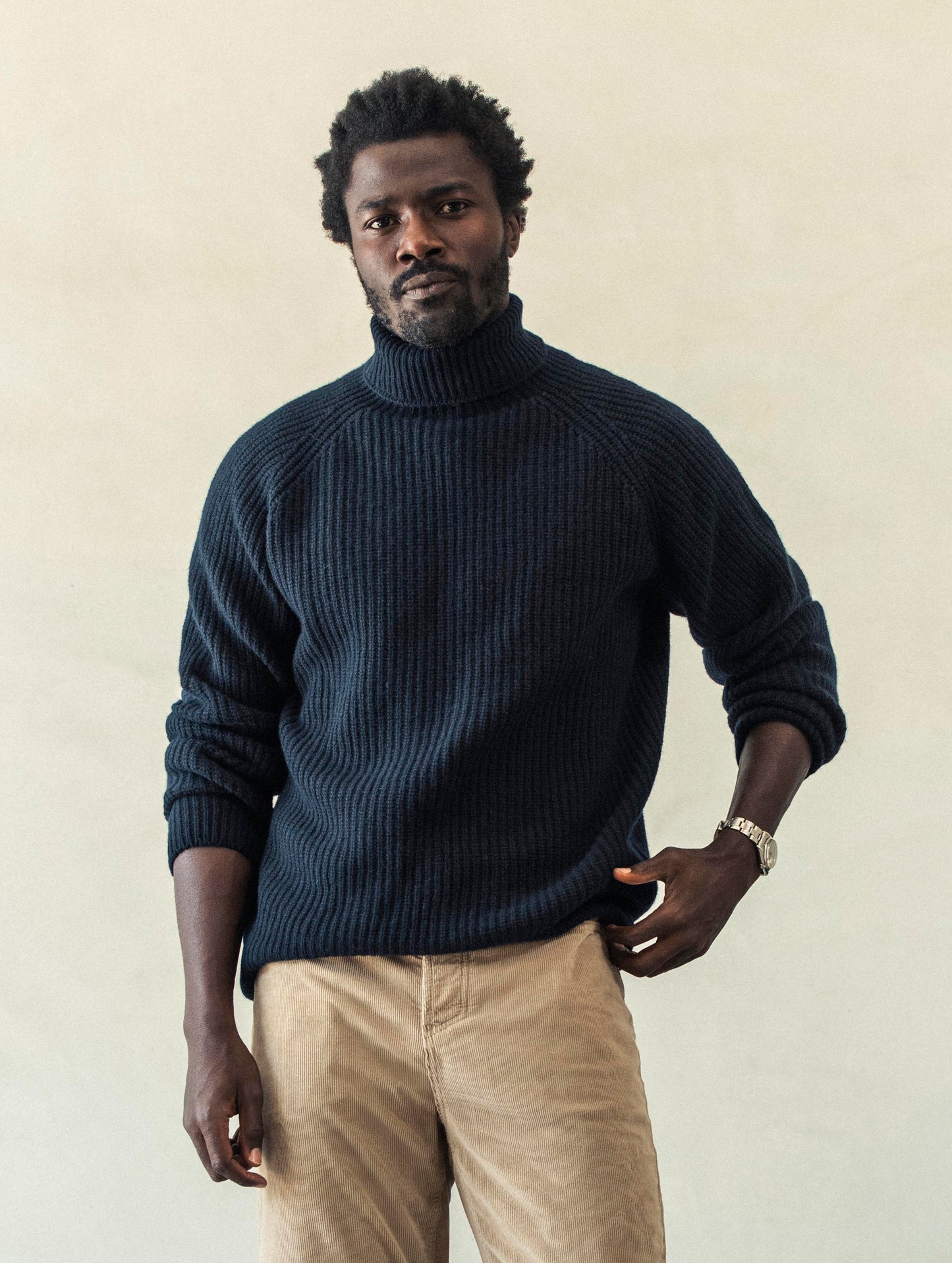 Front view of man wearing Finley Sweater in Total Eclipse dark blue from AETHER Apparel.