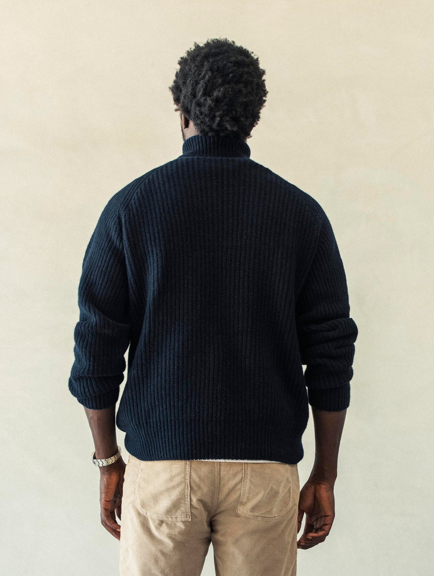 Rear view of man wearing Finley Sweater in Total Eclipse dark blue from AETHER Apparel.