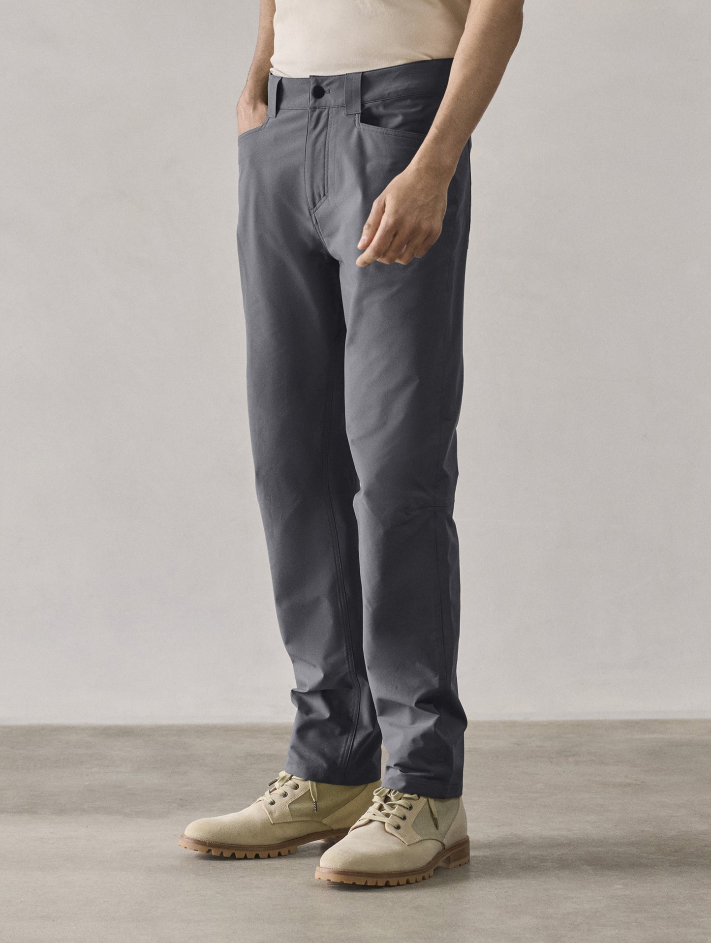 Front 3/4 lower-body view of man wearing Adventure Pant in Graphite from AETHER Apparel.