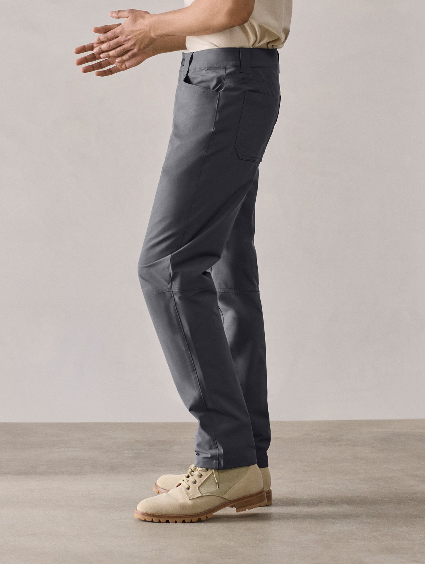 Side profile lower-body view of man wearing Adventure Pant in Graphite from AETHER Apparel.