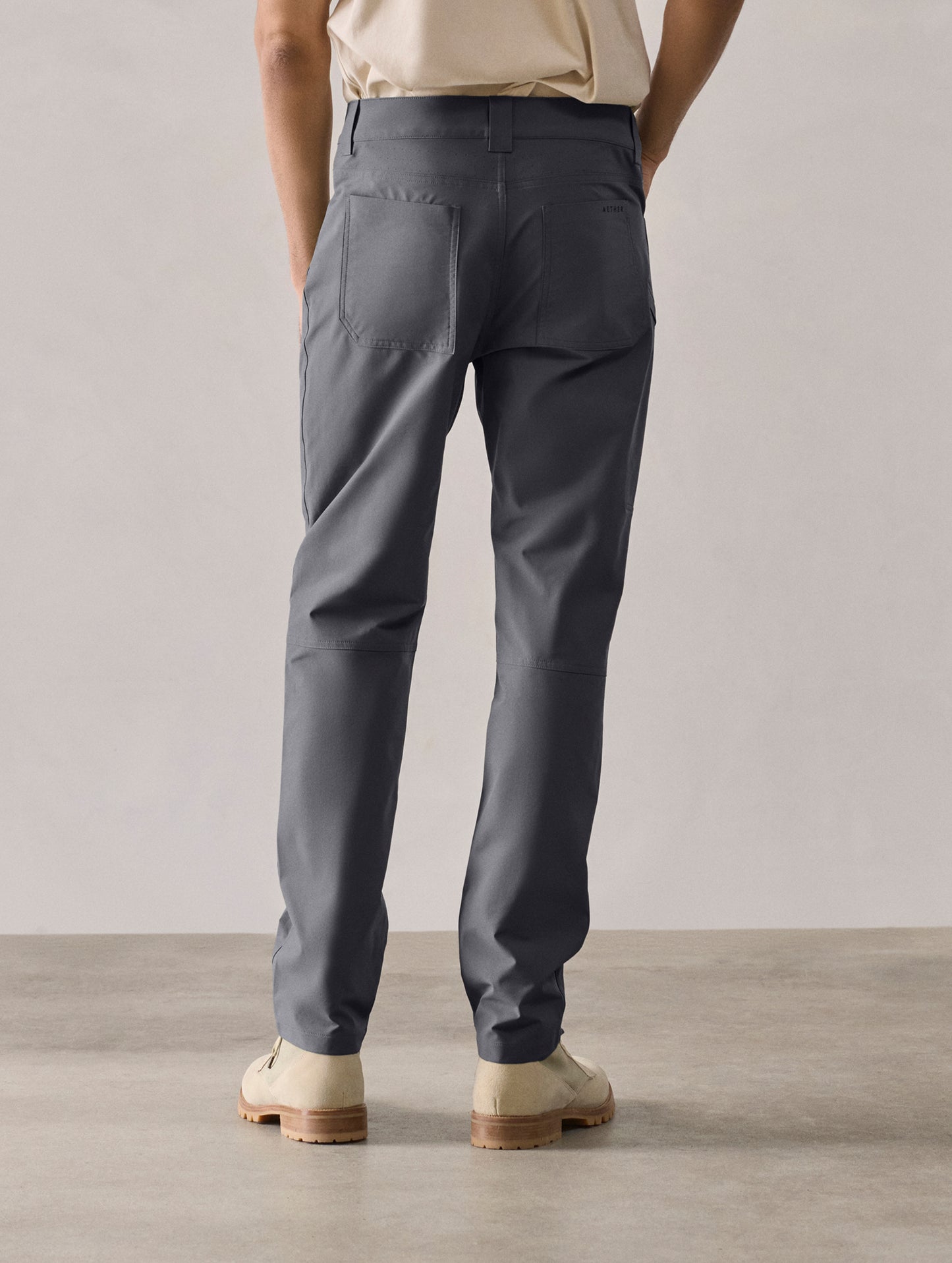 Rear lower-body view of man wearing Adventure Pant in Graphite from AETHER Apparel.