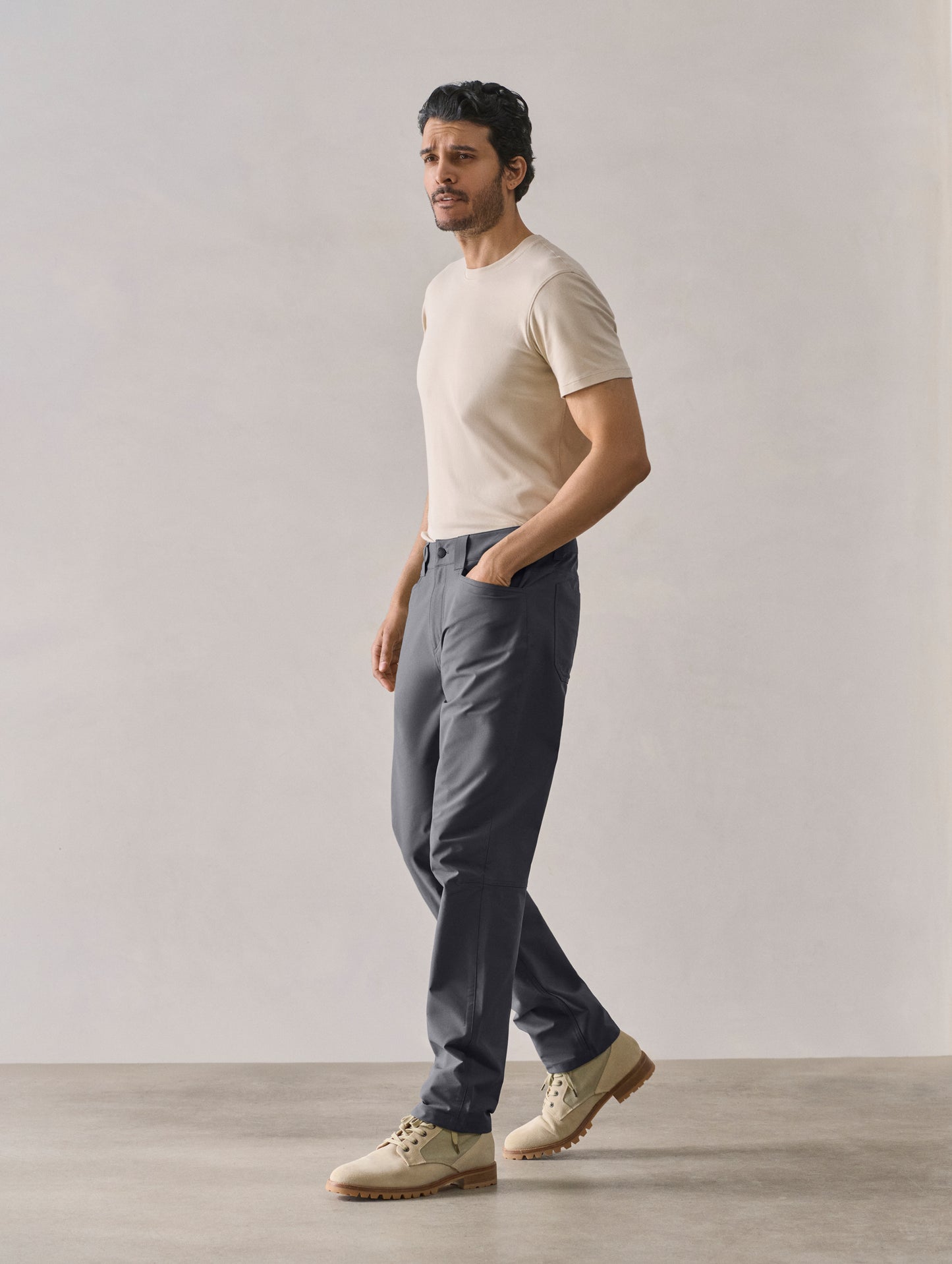 Front 3/4 full-body view of man wearing Adventure Pant in Graphite from AETHER Apparel.