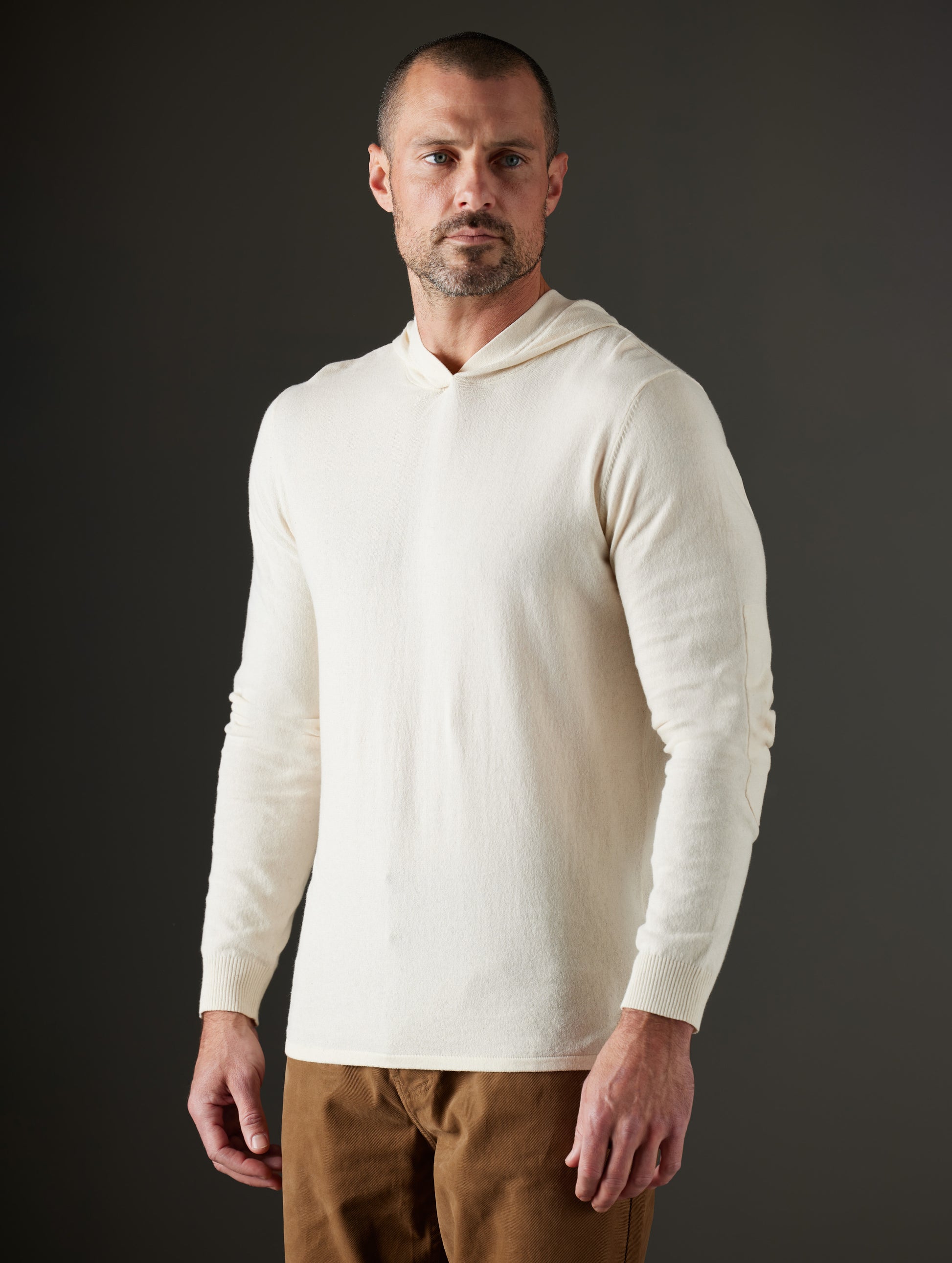 Man wearing beige hooded sweater from AETHER Apparel