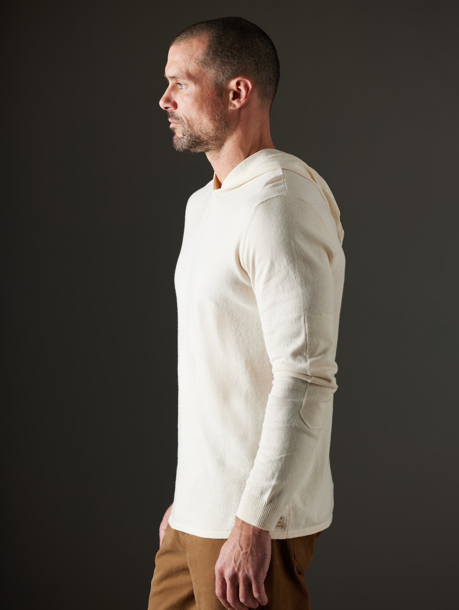 Man wearing beige hooded sweater from AETHER Apparel
