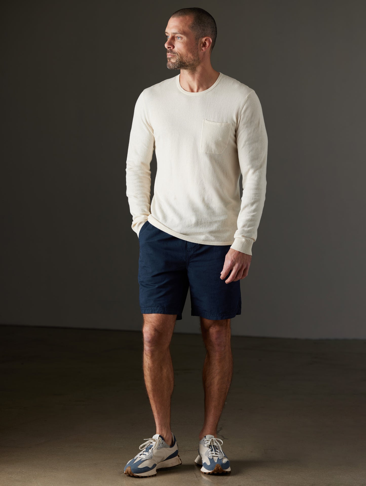 Front full-body view of man wearing Aero Sweater in Oatmeal Heather from AETHER Apparel.