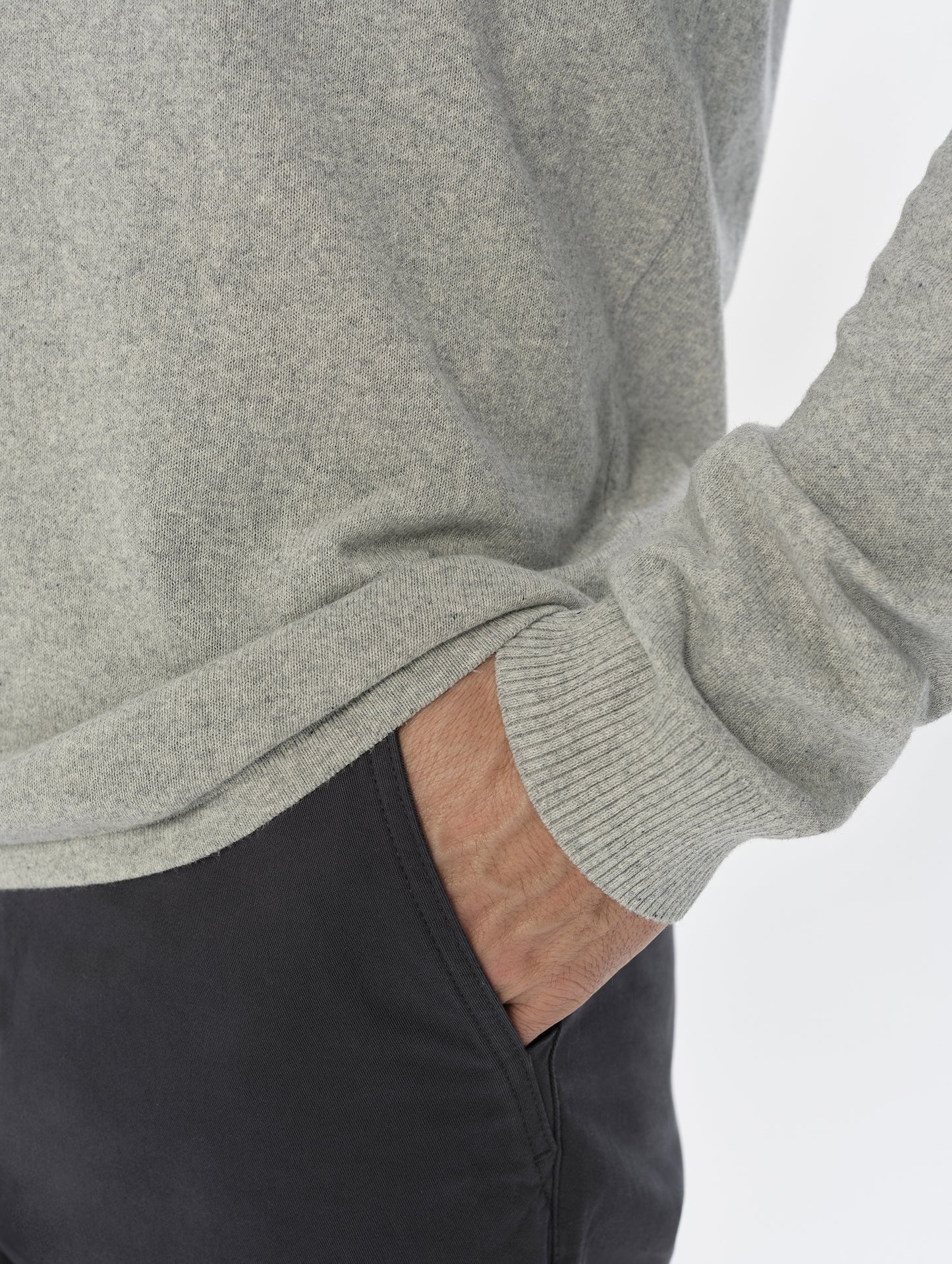 Closeup detailed view of the hem and sleeve cuff on the men's Aero Crewneck Sweater 2.0 in Alumino Grey from AETHER Apparel.