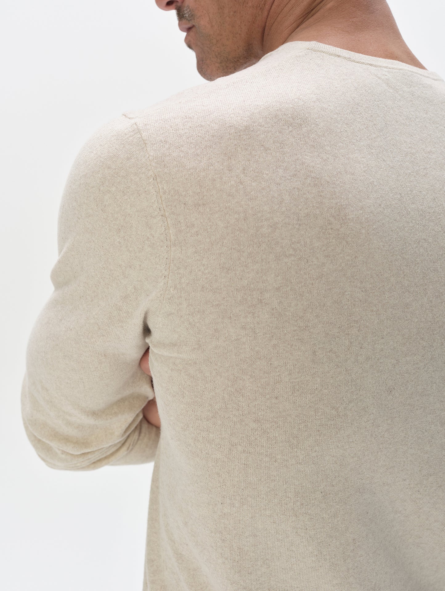 Closeup detailed view of the back shoulder of the men's Aero Crewneck Sweater 2.0 in Lino Tan from AETHER Apparel.