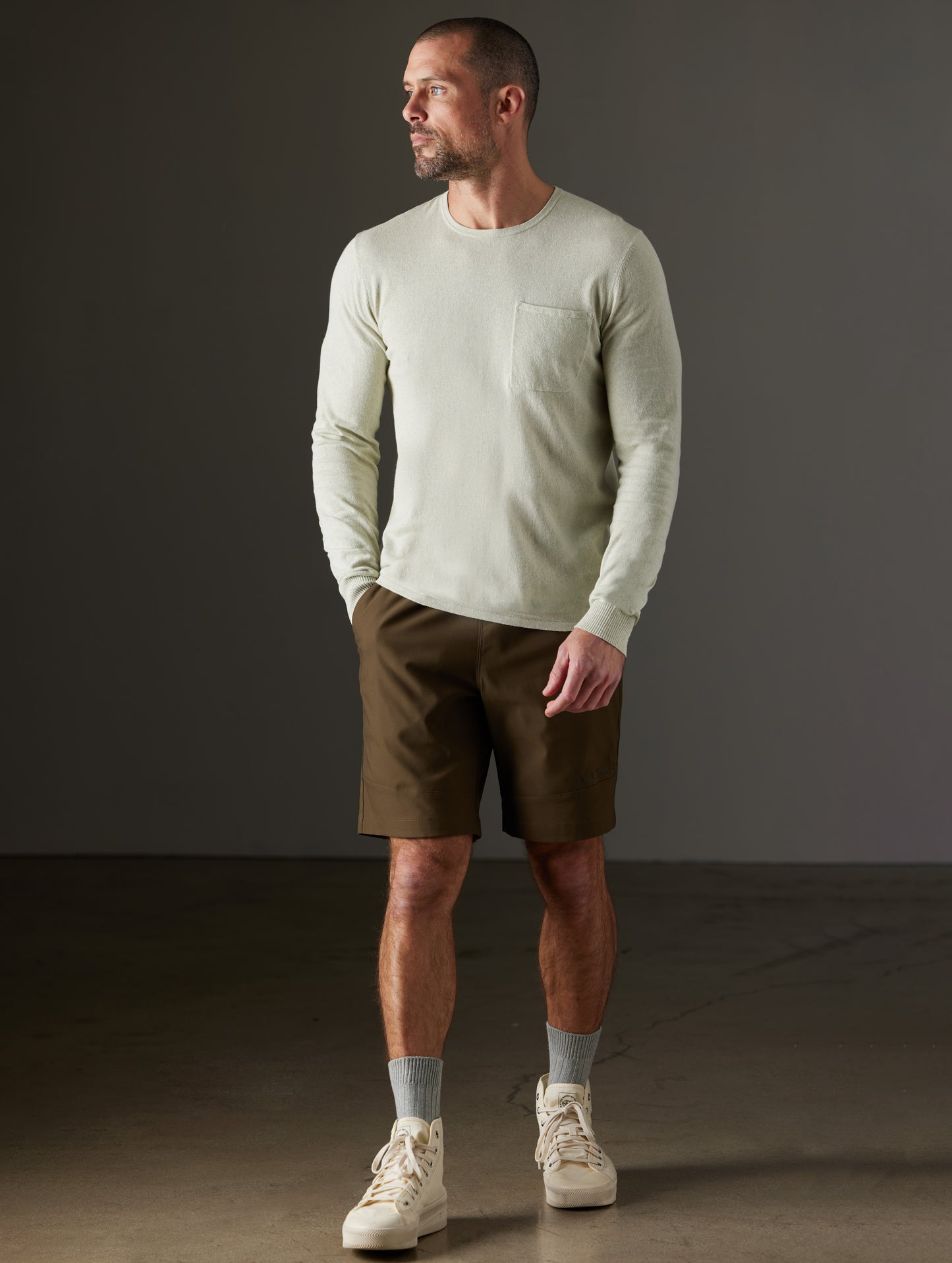 Front full-body view of man wearing Aero Sweater in Light Sage Heather from AETHER Apparel.
