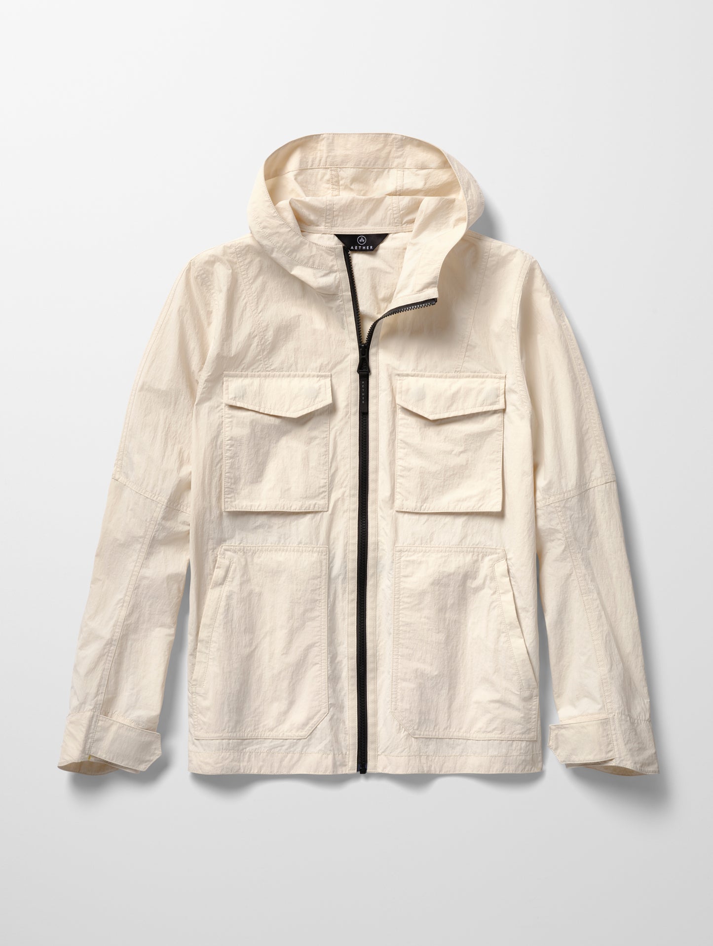 Flat lay image of men's Aires Lightweight Windbreaker in Bone white from AETHER Apparel.
