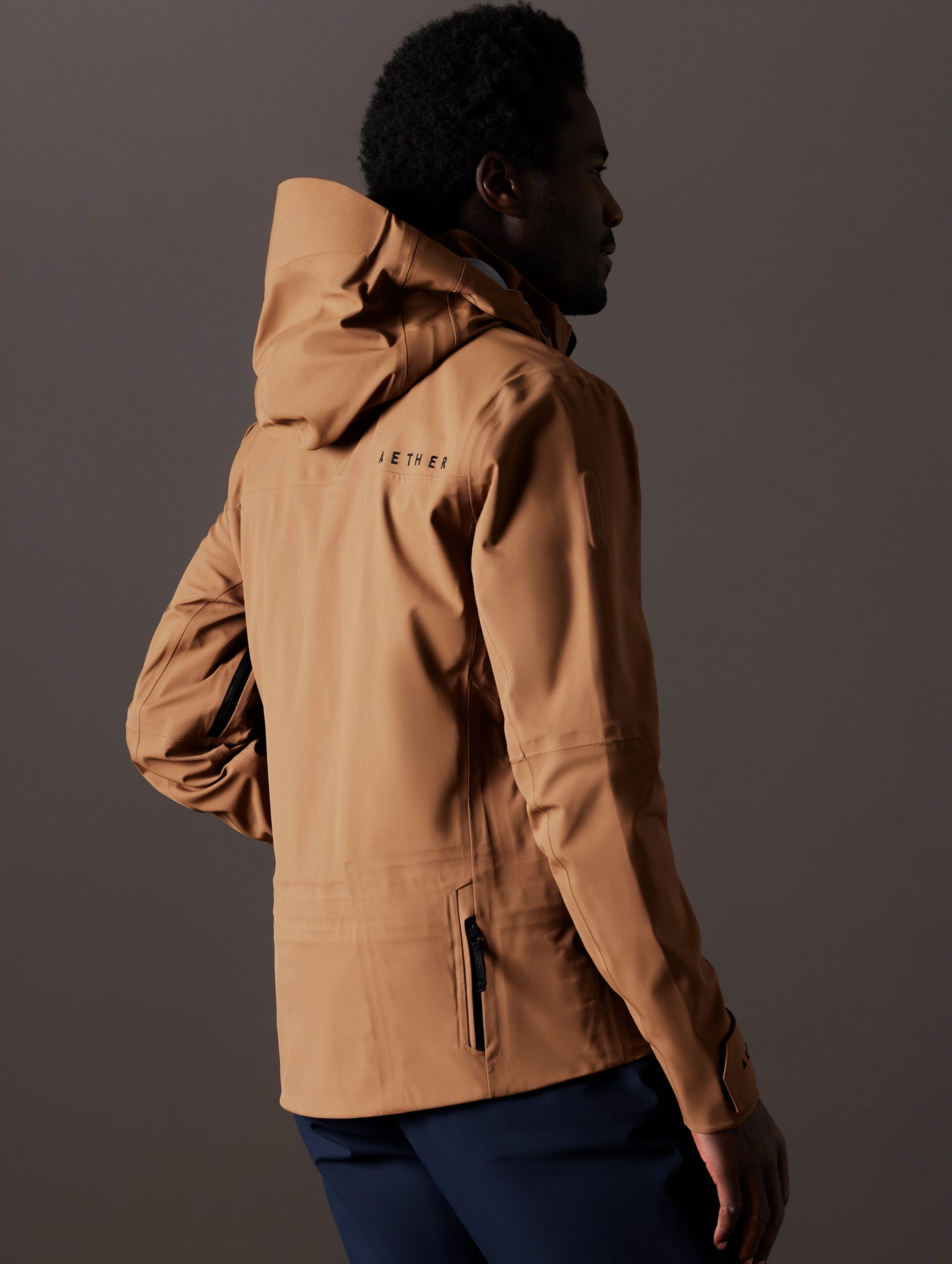 man wearing brown snow shell from AETHER Apparel
