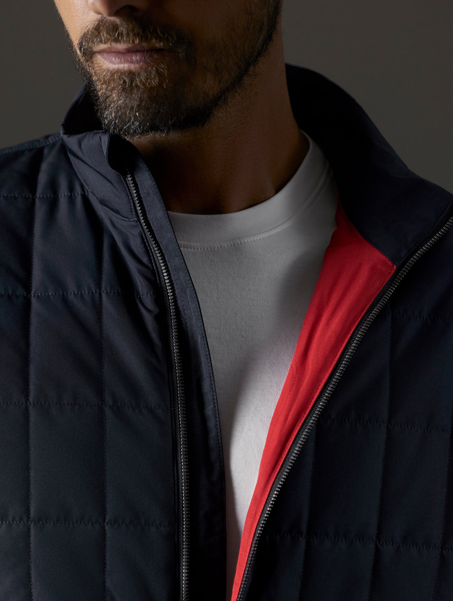 Closeup detailed view of main zipper on Alto Jacket 2.0 in Onyx Black from AETHER Apparel.