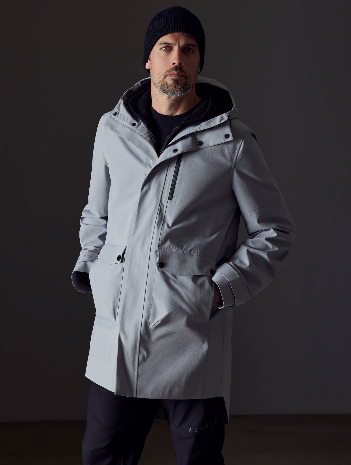 Front body view of man wearing Anders Rain Jacket in Sky Grey from AETHER Apparel.