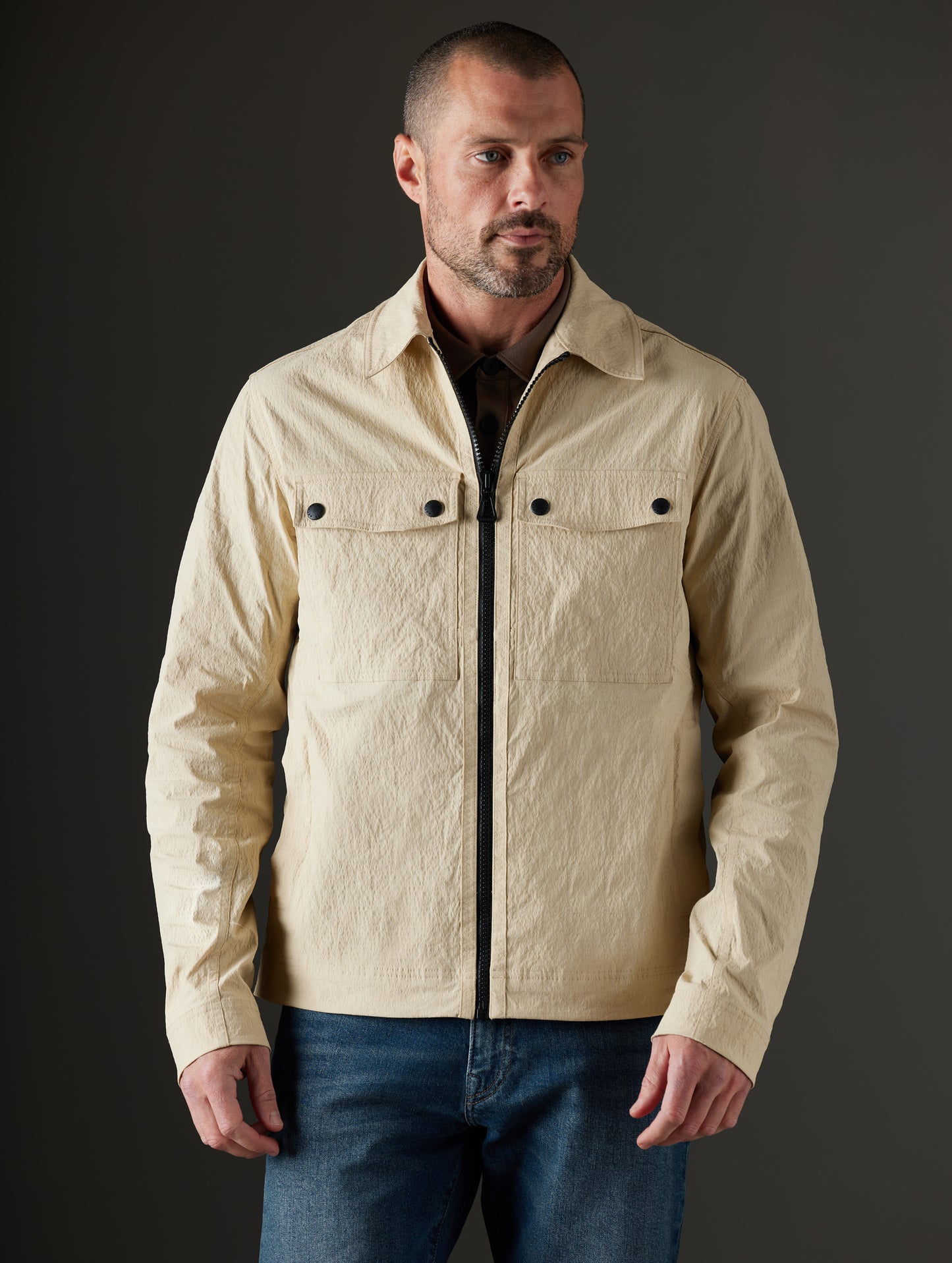 Front body view of man wearing Baxter Jacket in Desert Tan from AETHER Apparel.