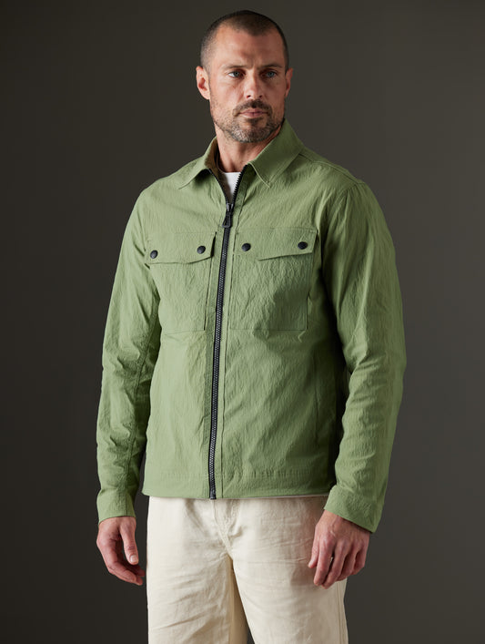 Front body view of man wearing Baxter Jacket in Mineral Green from AETHER Apparel.