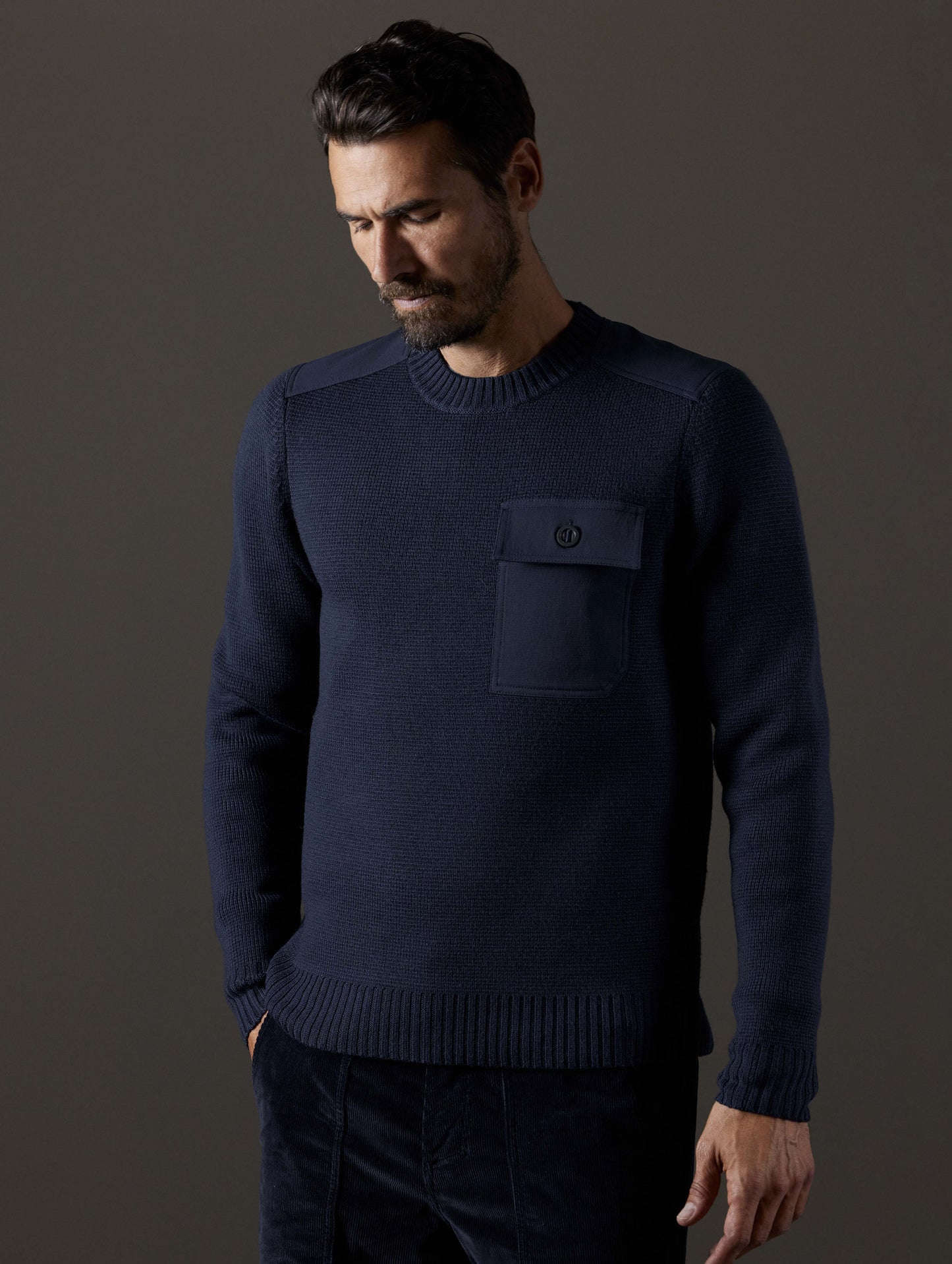 Front body view of man wearing Benson Crewneck Sweater in Total Eclipse dark blue from AETHER Apparel.