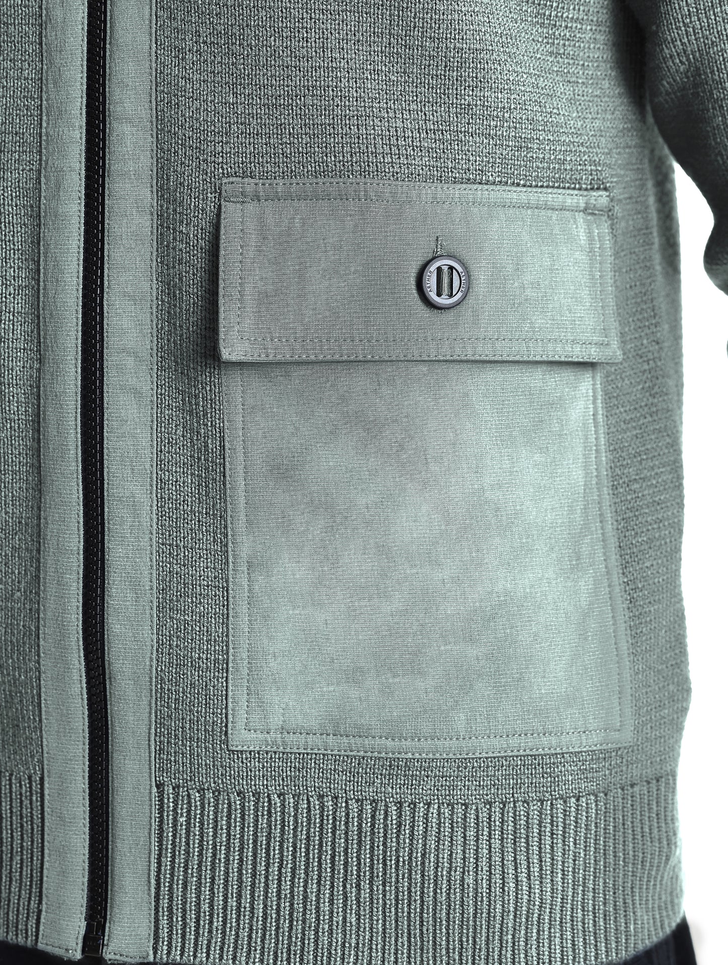 Closeup view of wearer's left patch pocket of Benson Full-Zip Sweater in Gunmetal grey from AETHER Apparel.
