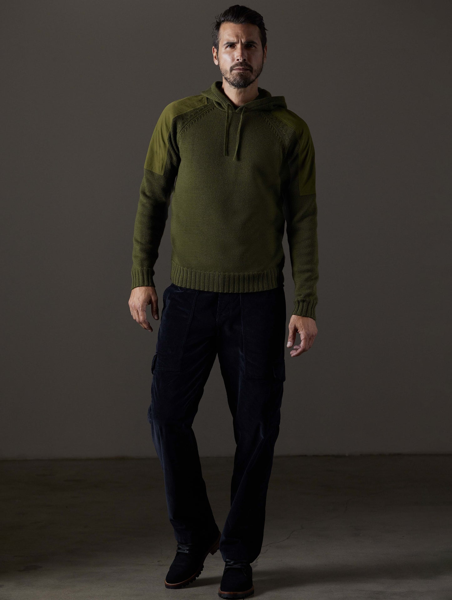 Front full-body view of man wearing Benson Hooded Sweater in Command Green from AETHER Apparel.