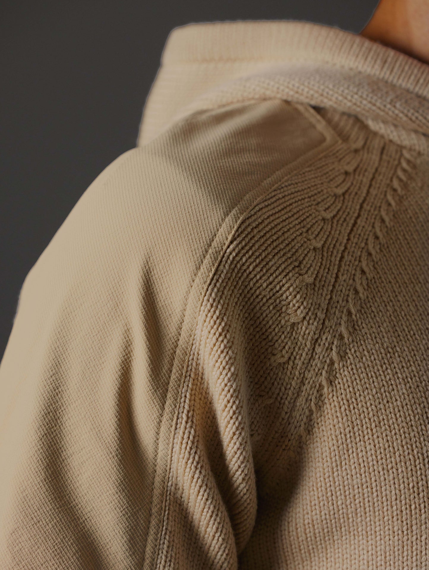 Closeup detailed view of ornate Milano stitching detail on shoulder of Benson Hooded Sweater in Oatmeal beige from AETHER Apparel.