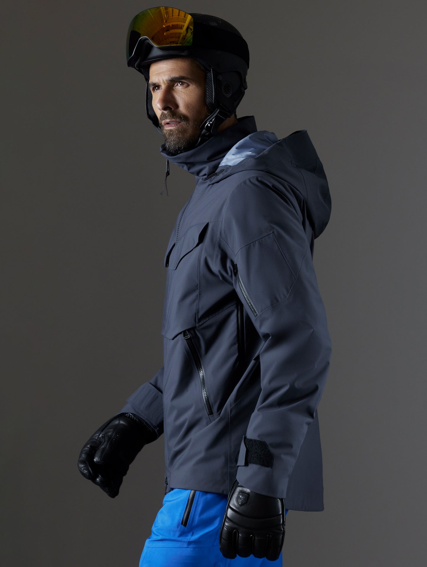 Side profile body view of man wearing Brighton Insulated Snow Jacket in Graphite from AETHER Apparel.