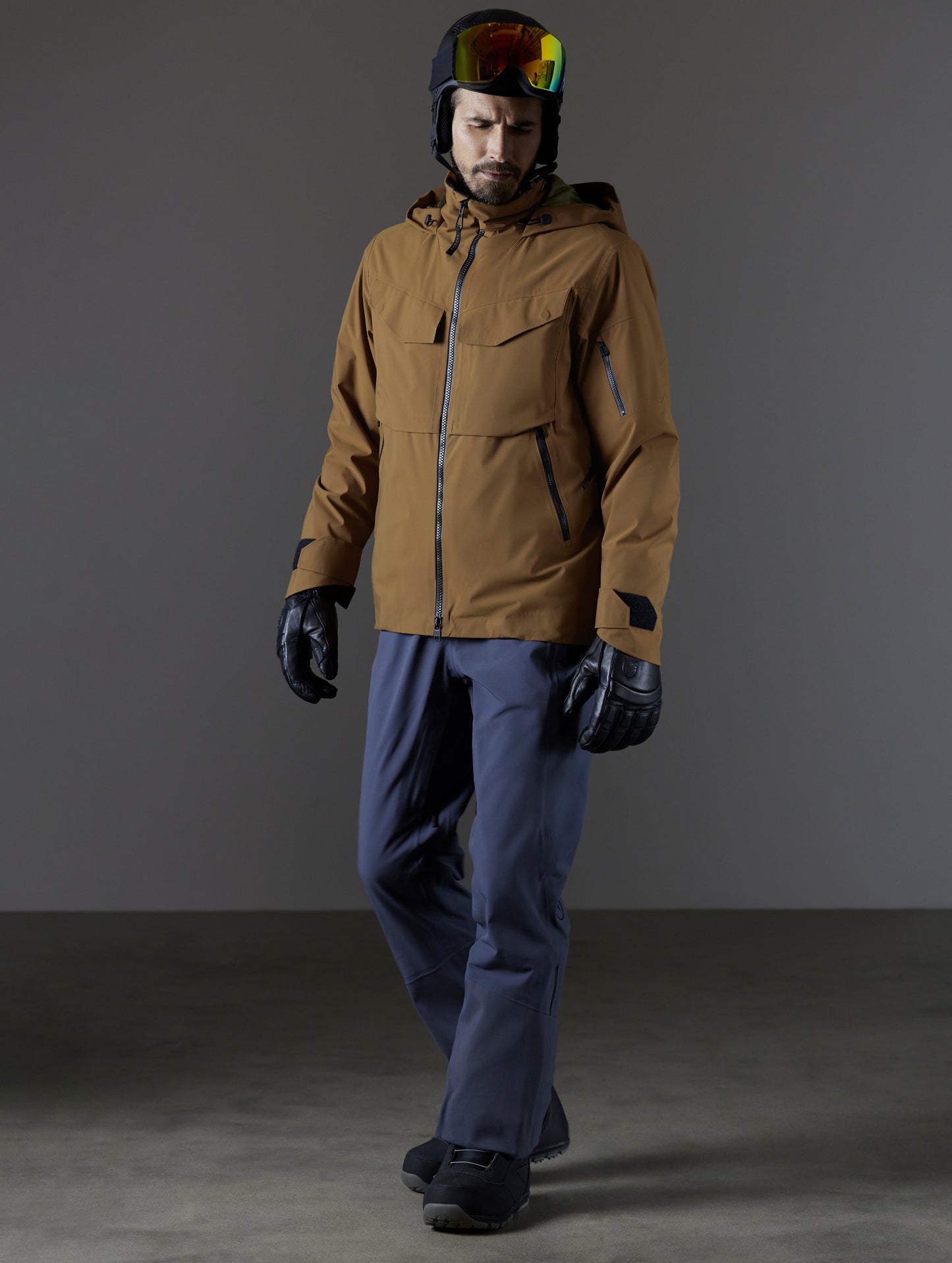 Front 3/4 full body view of man wearing Brighton Insulated Snow Jacket in Rubber Brown from AETHER Apparel.