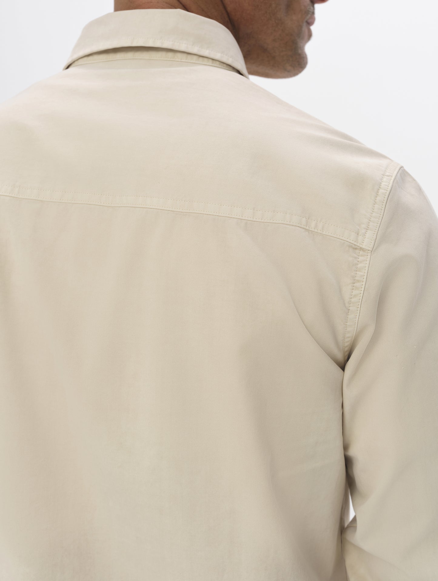 Closeup detailed view of the shoulders, collar, and back yoke on the Caden Work Shirt in Bone from AETHER Apparel.
