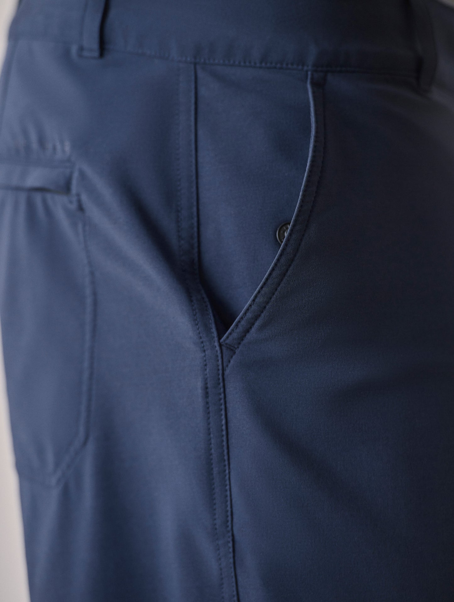Closeup detailed shot of slant hand pocket and zipper-secured back welt pocket on Catalina Submersible Short in Total Eclipse dark blue from AETHER Apparel.