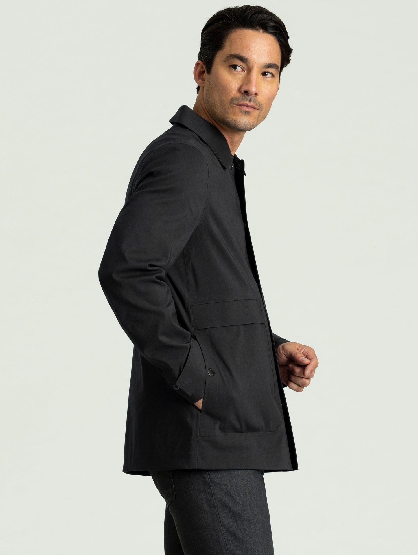 Side view of man wearing black Cole Jacket from AETHER Apparel.