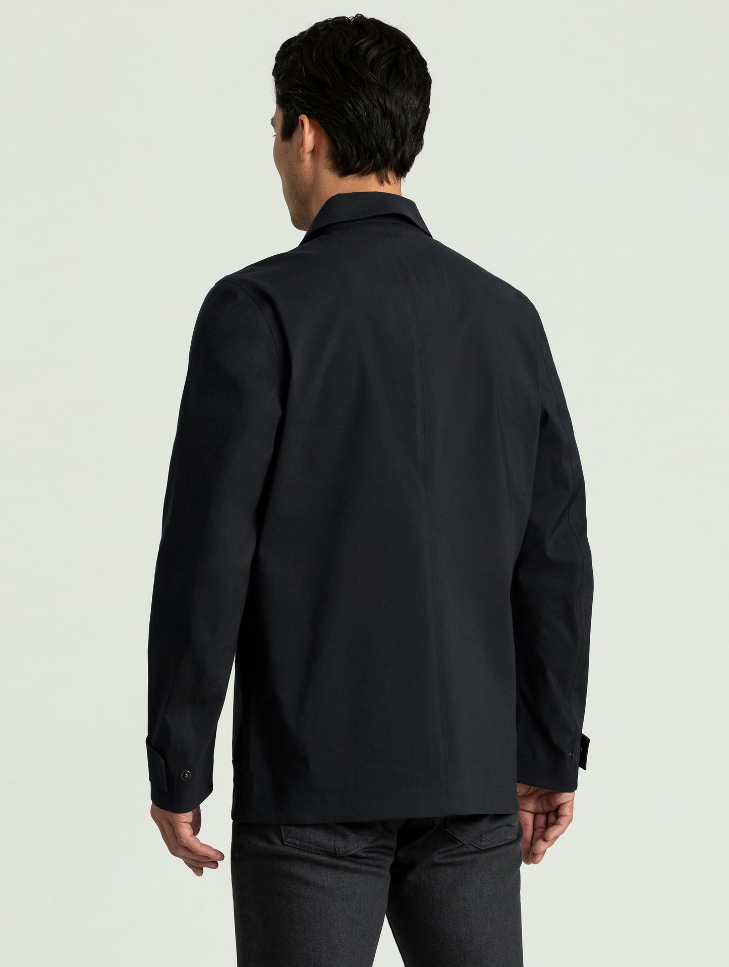 Back view of man wearing black Cole Jacket from AETHER Apparel.