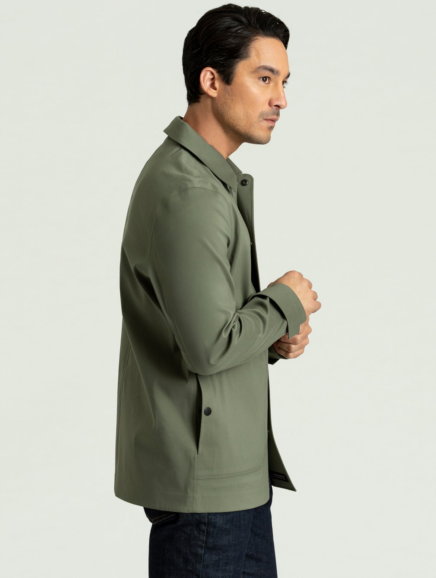 Side view of man wearing Cole Jacket in spruce green from AETHER Apparel.