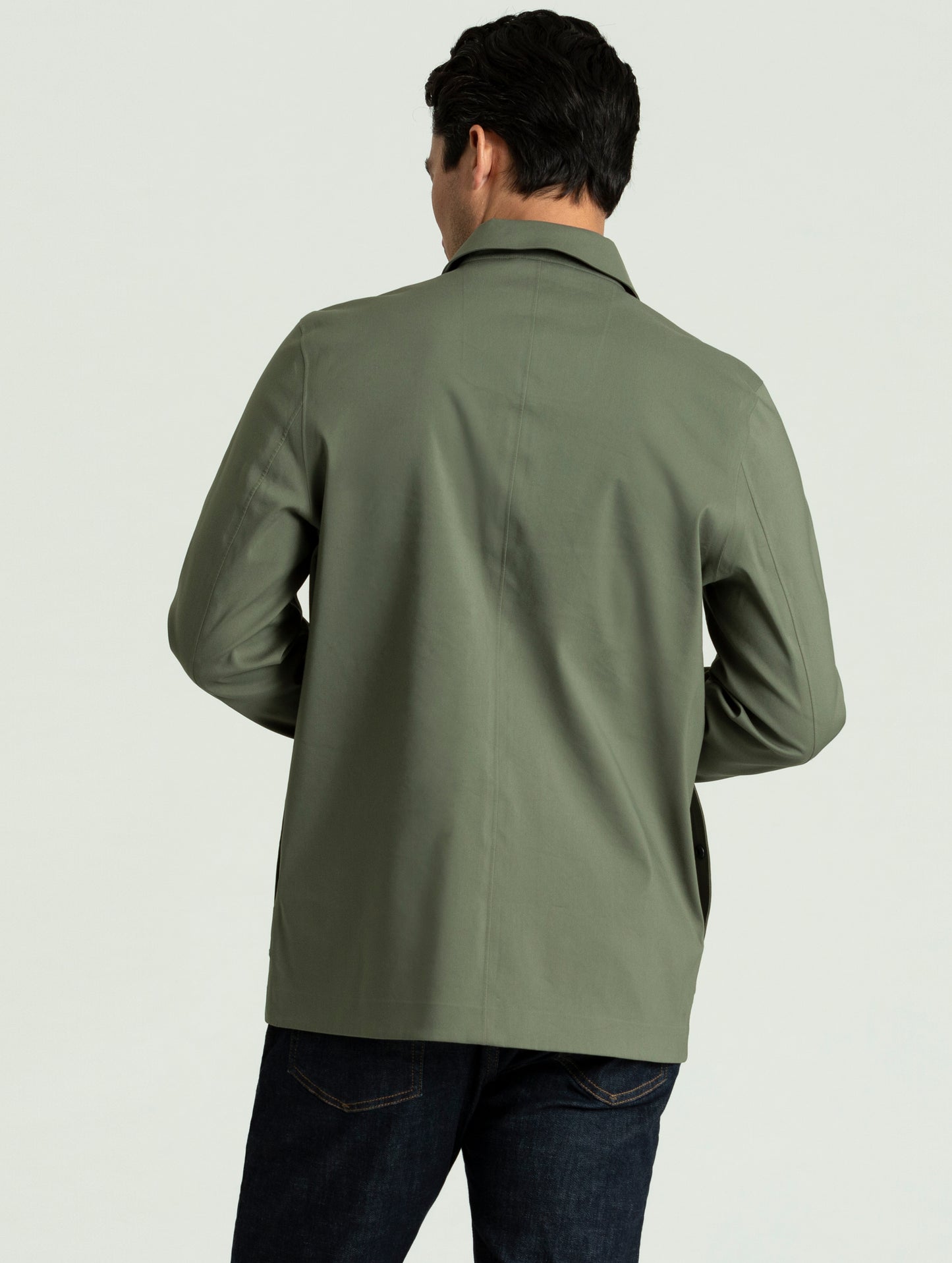 Back view of man wearing Cole Jacket in spruce green from AETHER Apparel.