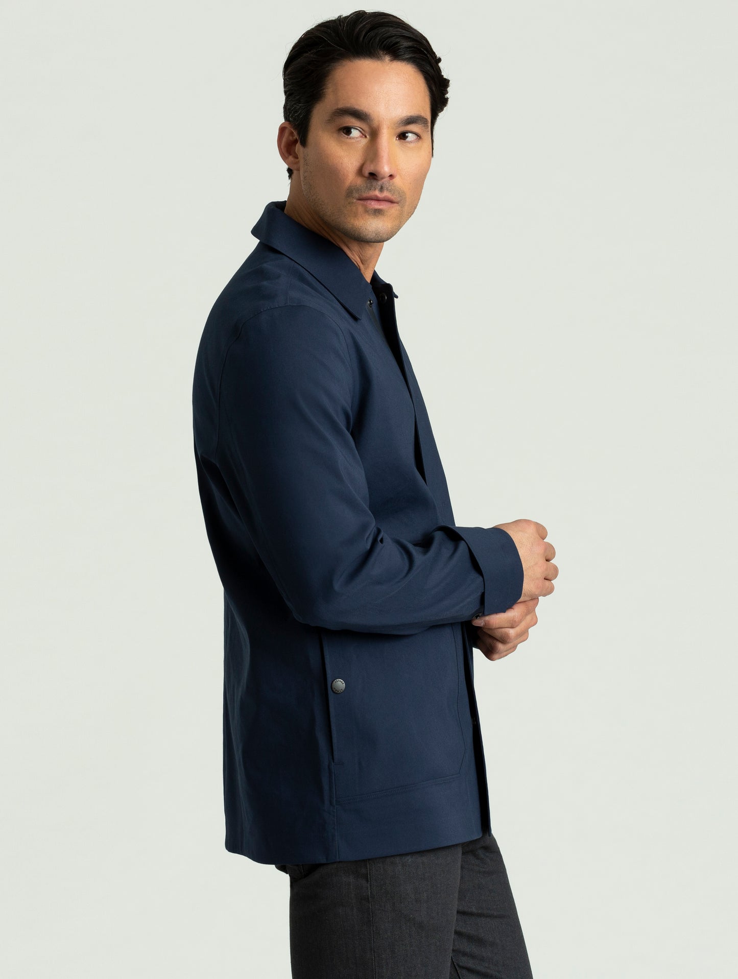 Side view of man wearing Cole Jacket in dark blue from AETHER Apparel.