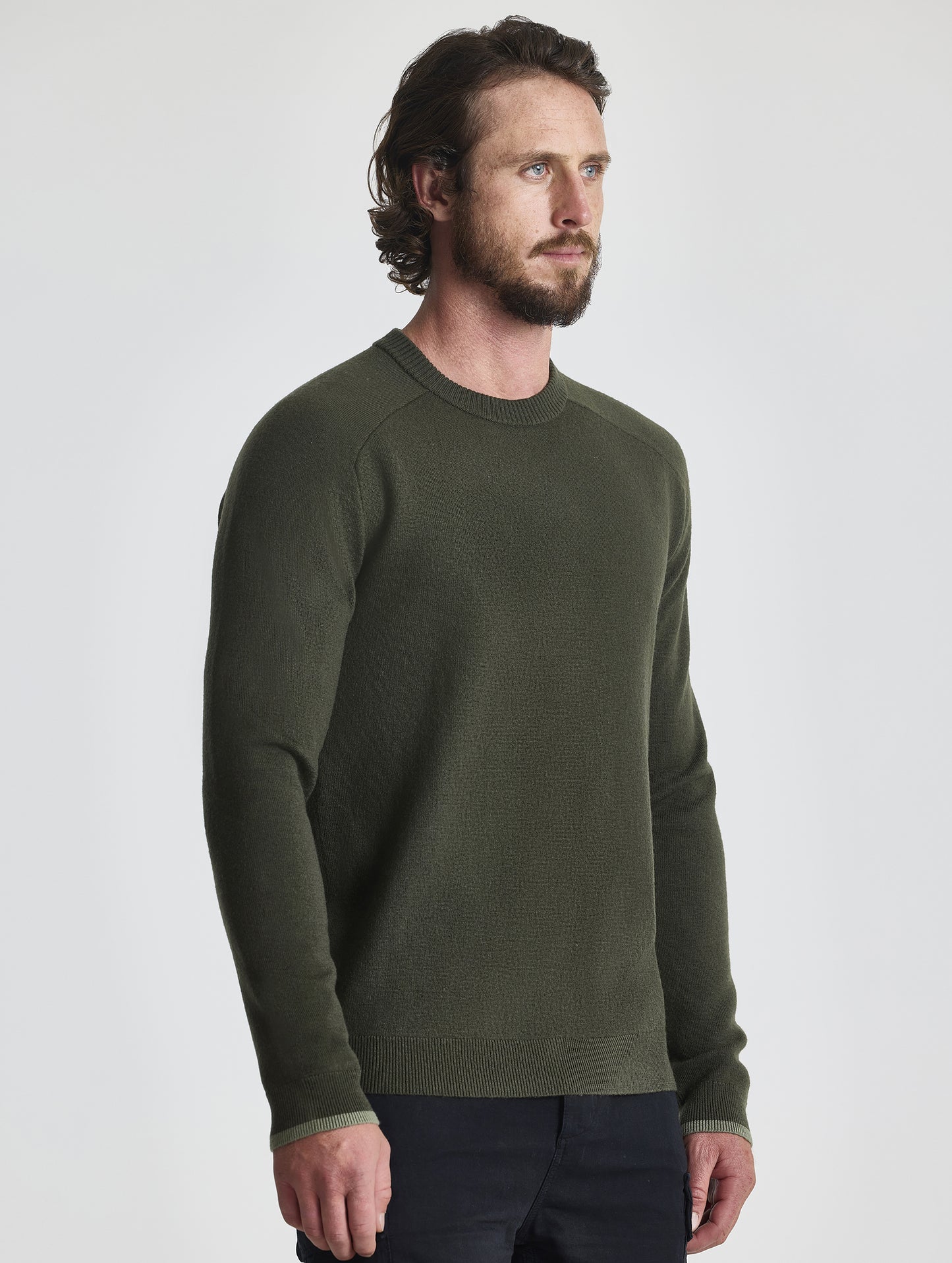 Angled view of man wearing Corbin Sweater in Forest Green from AETHER Apparel.