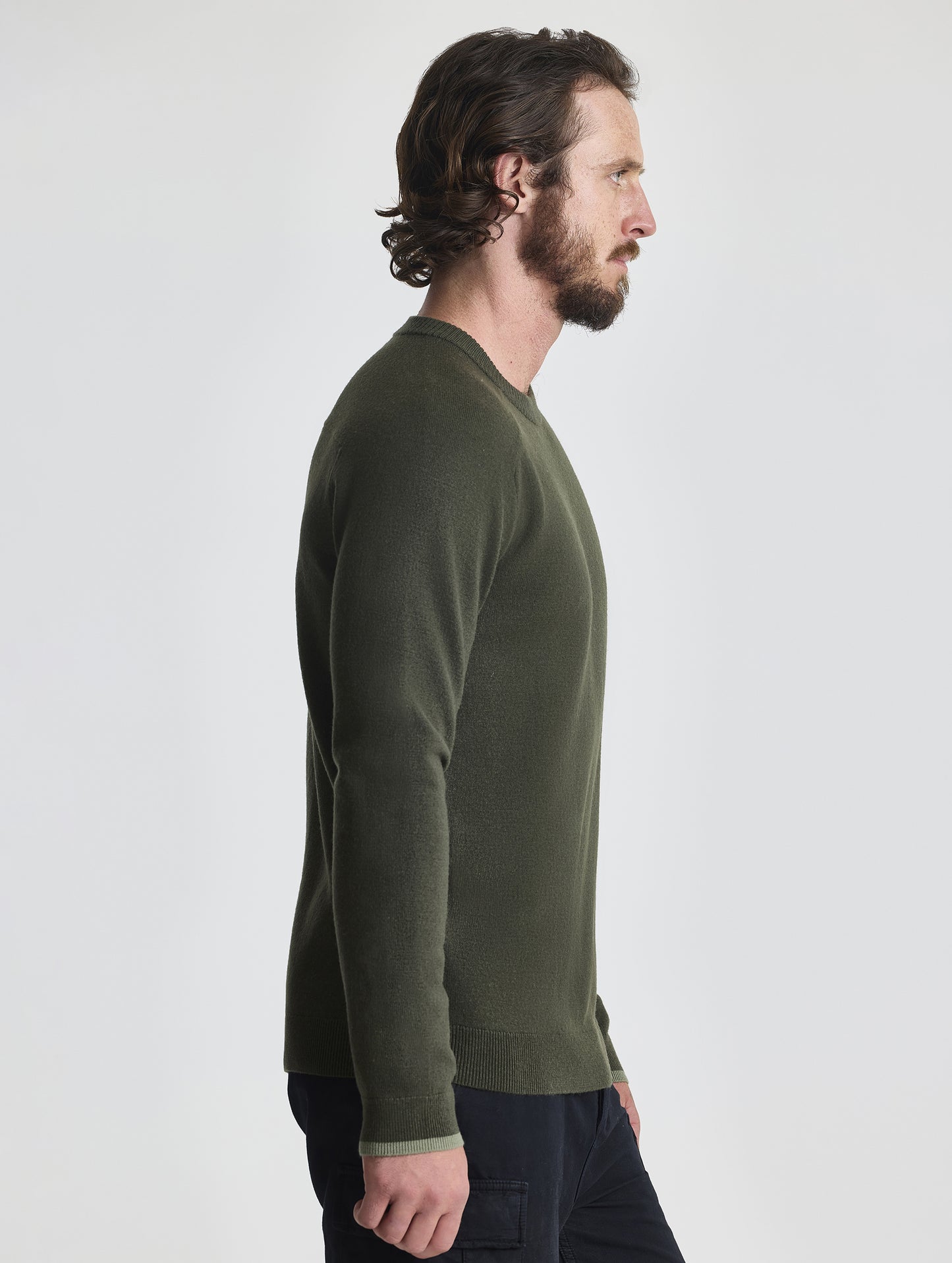 Right profile view of man wearing Corbin Sweater in Forest Green from AETHER Apparel.