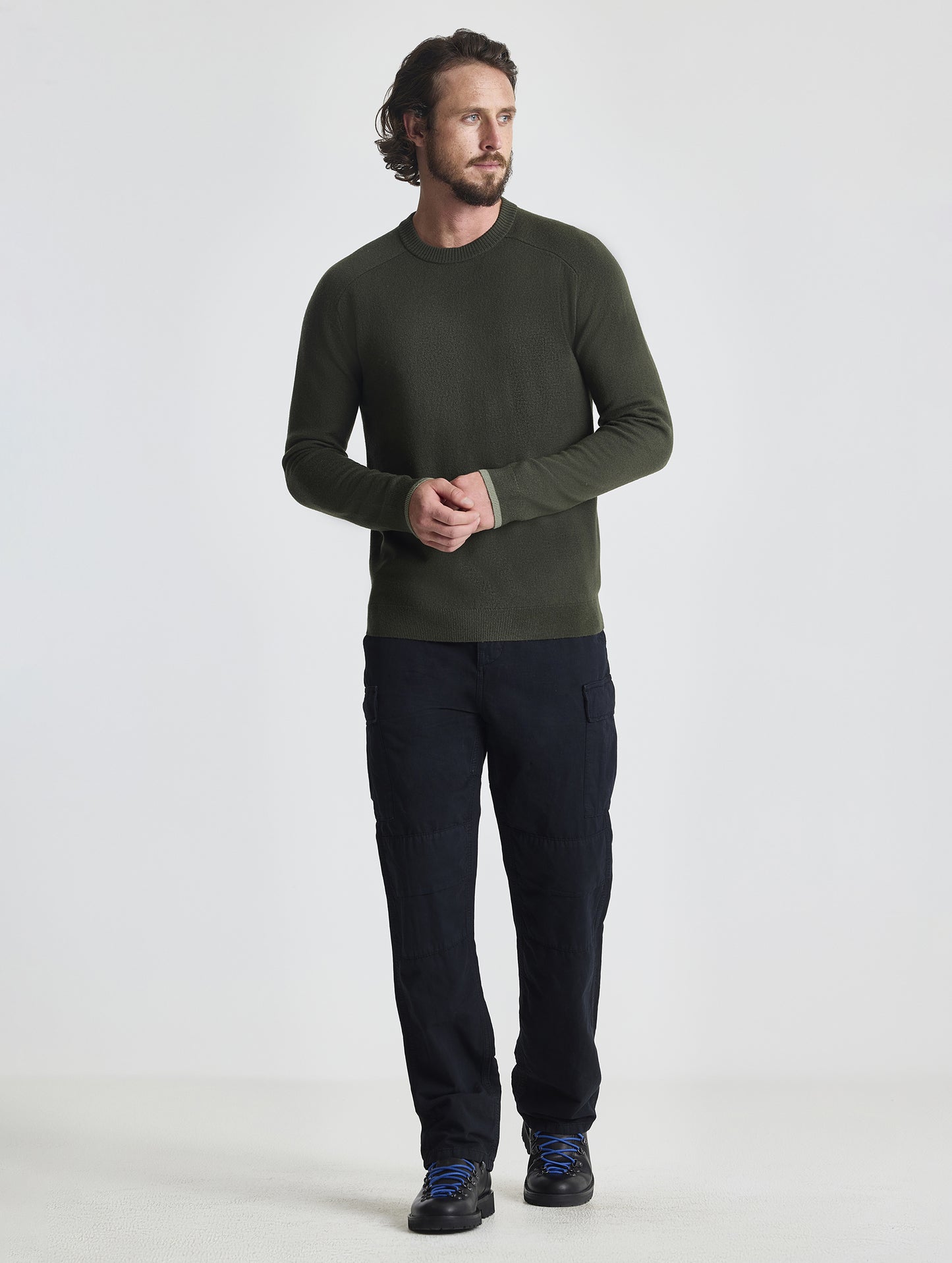 Full body view of man wearing Corbin Sweater in Forest Green from AETHER Apparel.