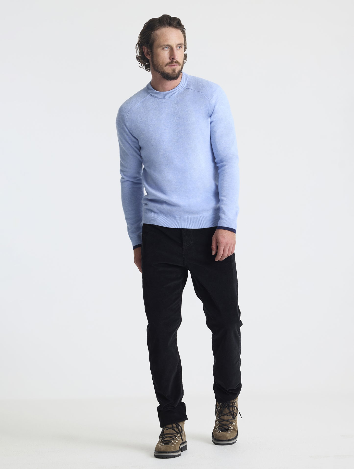 Full body view of man wearing Corbin Sweater in Light Blue Heather from AETHER Apparel.