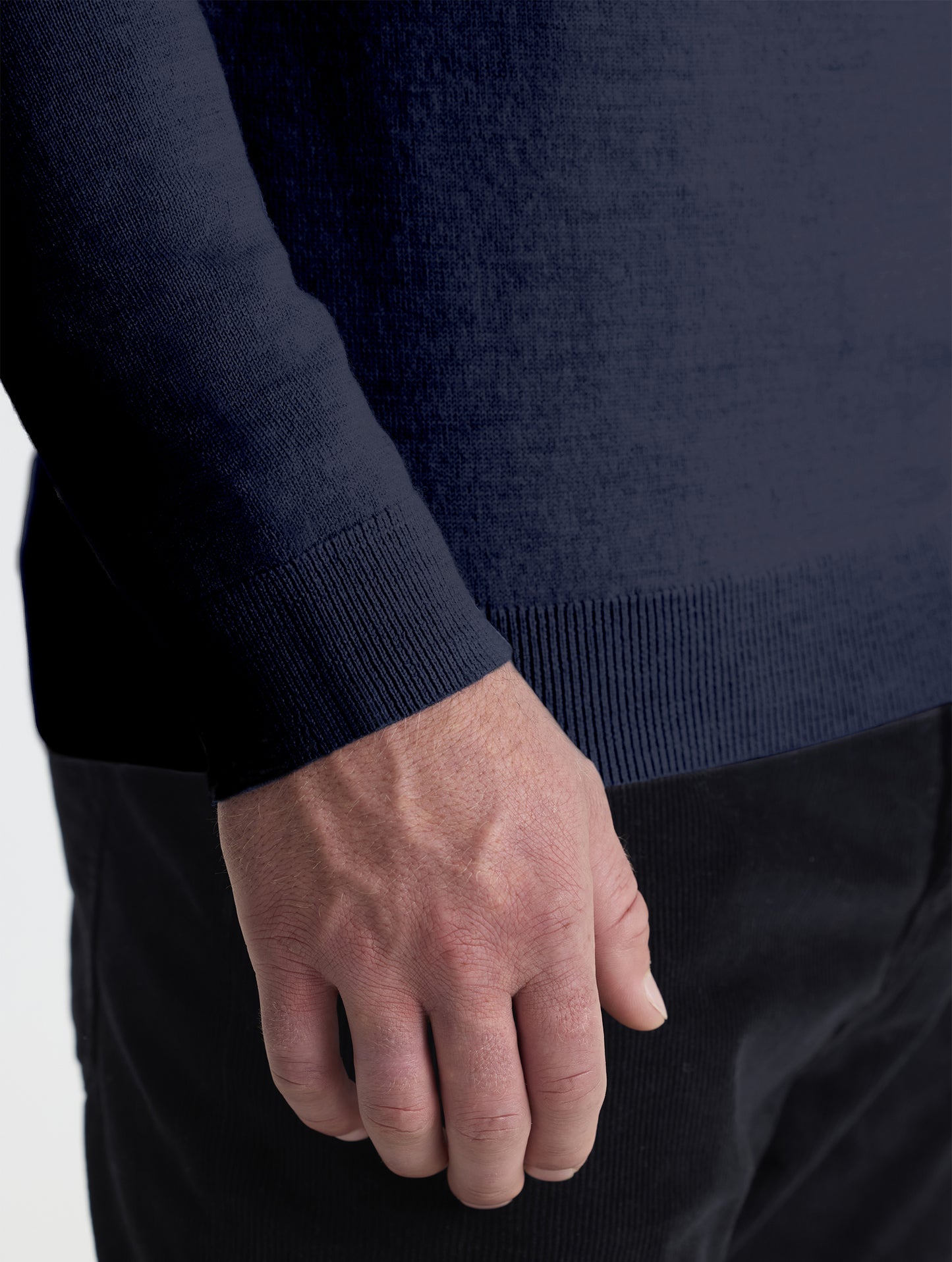 Closeup detail view of wearer's right sleeve of Corbin Sweater in Total Eclipse dark blue from AETHER Apparel.