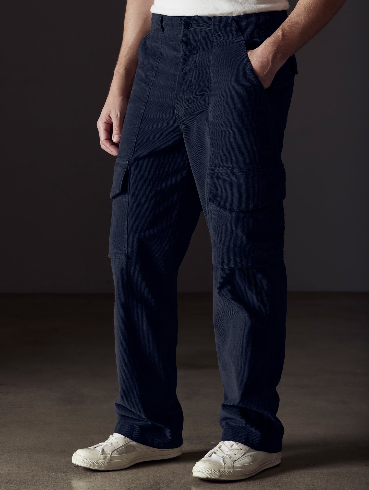 Front angled lower body view of man wearing Corduroy Fatigue Pant in Total Eclipse dark blue from AETHER Apparel.