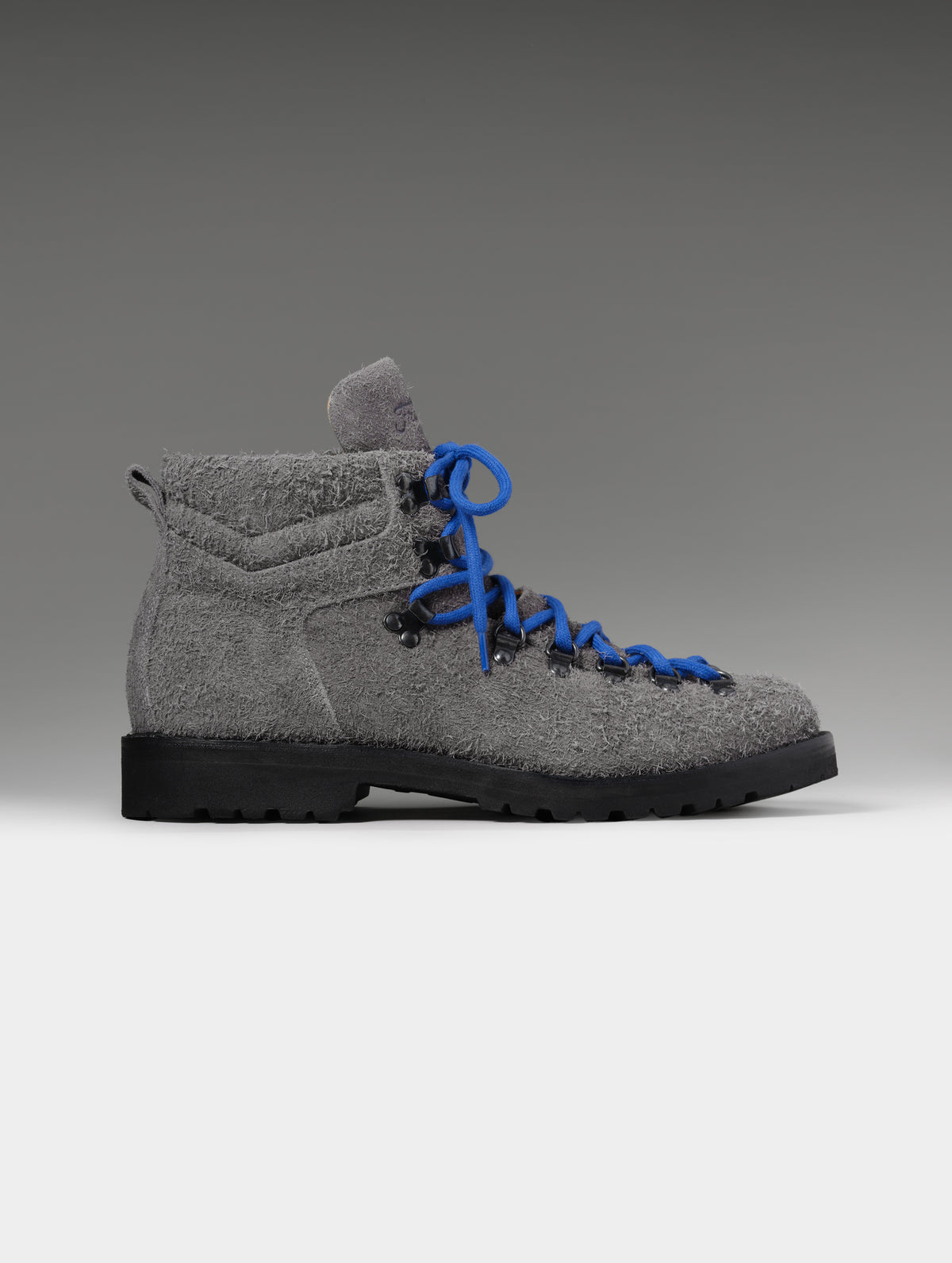 Side profile studio shot of the Dolomite Boot in Cement with blue laces from AETHER Apparel.
