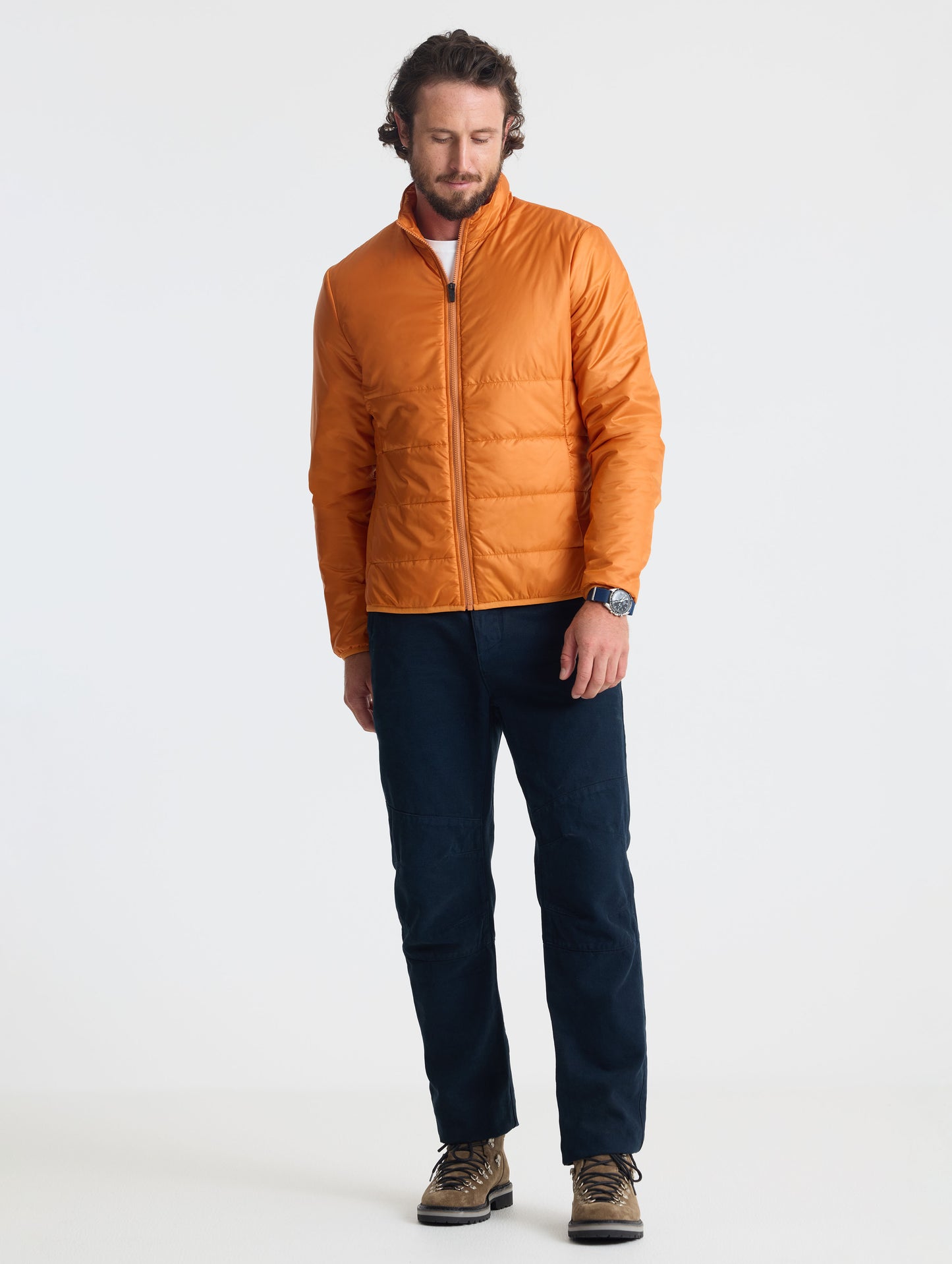 Full body view of man wearing Eco Insulated Jacket in Autumn Orange from AETHER Apparel.