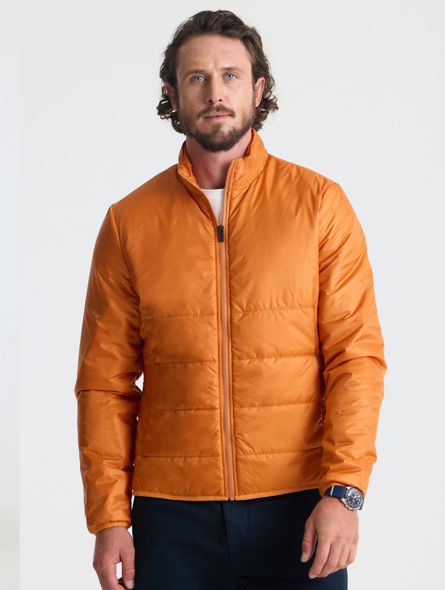 Front view of man wearing Eco Insulated Jacket in Autumn Orange from AETHER Apparel.