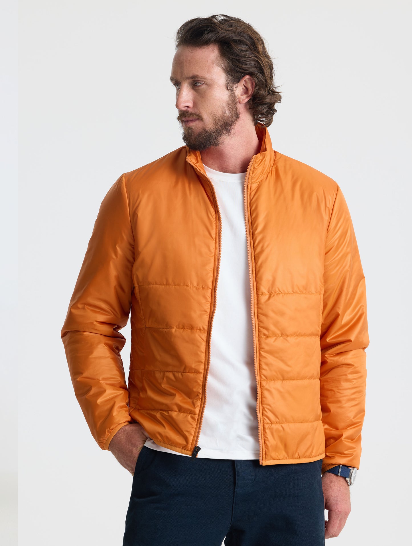 Front view of man wearing unzipped Eco Insulated Jacket in Autumn Orange from AETHER Apparel.