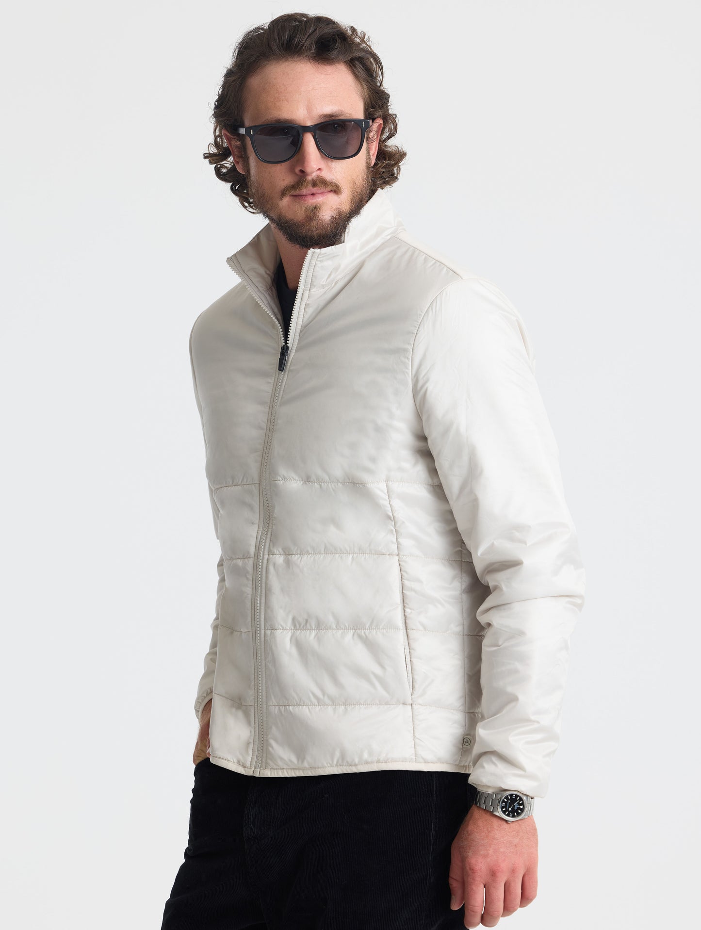 Front angled view of man wearing Eco Insulated Jacket in Bone white from AETHER Apparel.