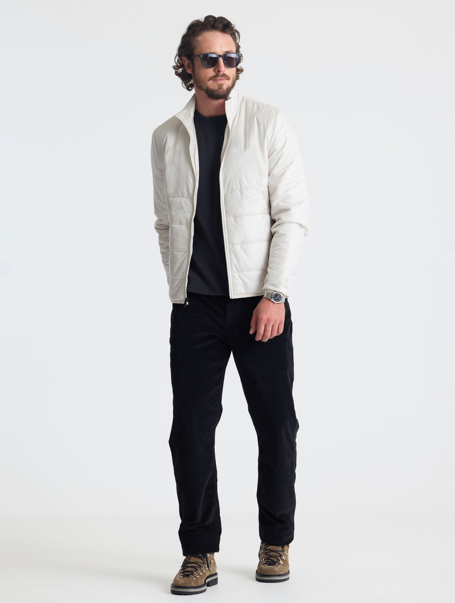 Full body view of man wearing Eco Insulated Jacket in Bone white from AETHER Apparel.