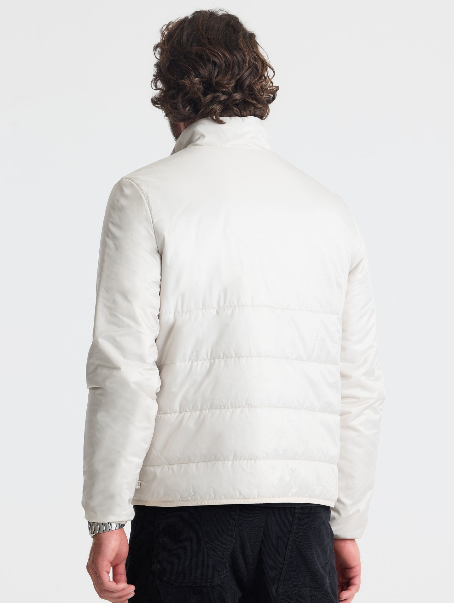 Rear view of man wearing Eco Insulated Jacket in Bone white from AETHER Apparel.