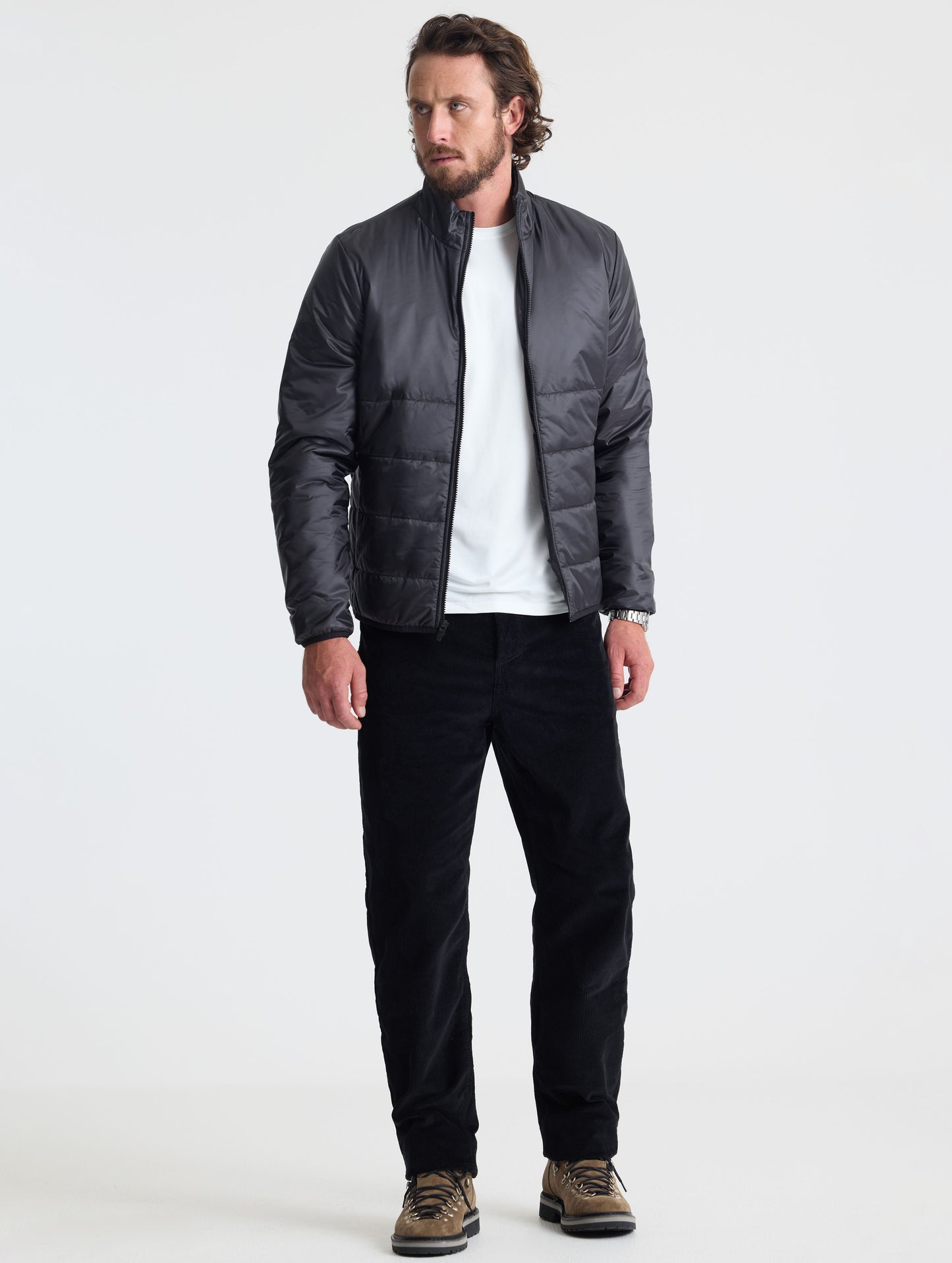 Full body view of man wearing Eco Insulated Jacket in Onyx Black from AETHER Apparel.