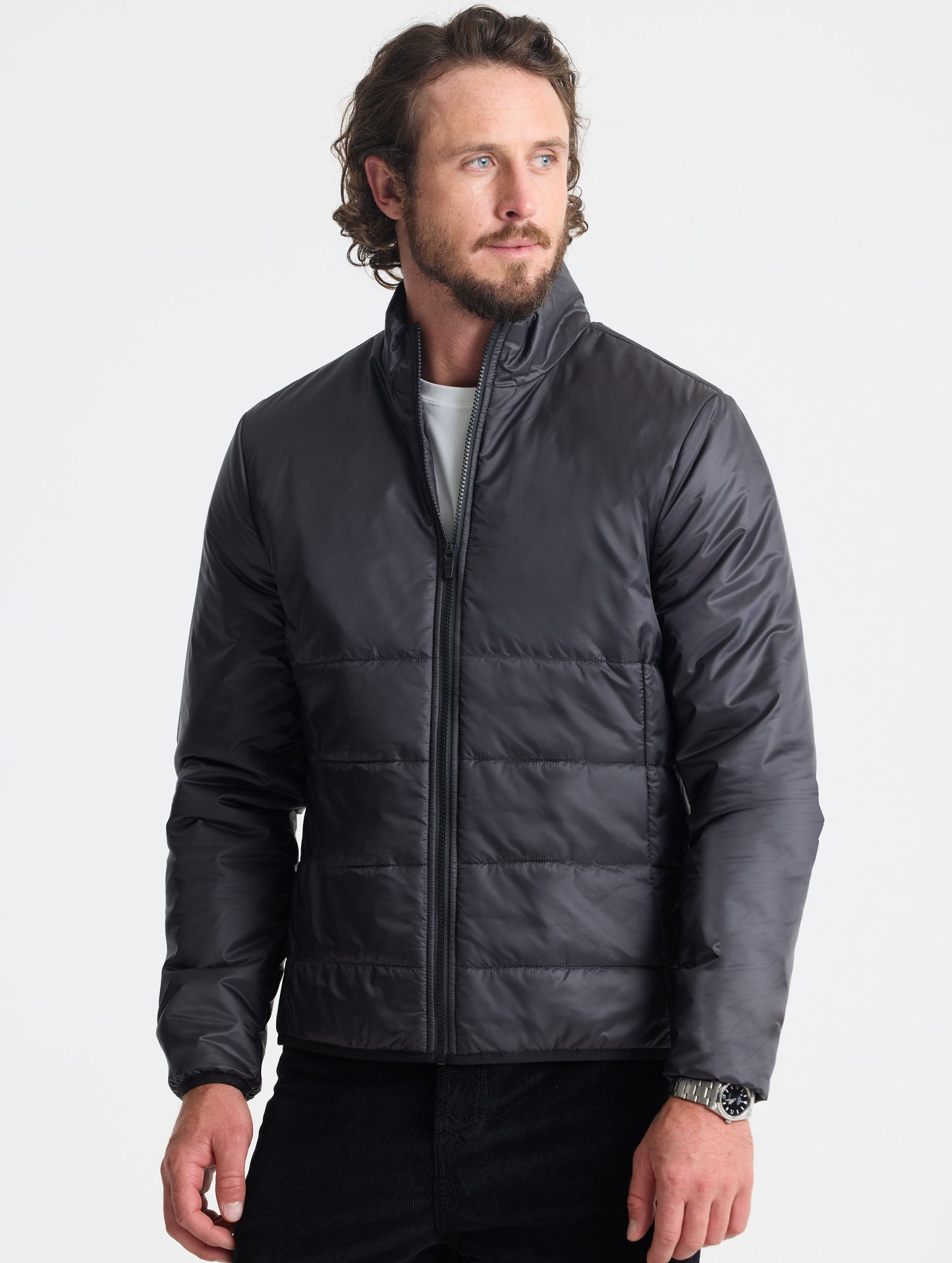 Front view of man wearing Eco Insulated Jacket in Onyx Black from AETHER Apparel.